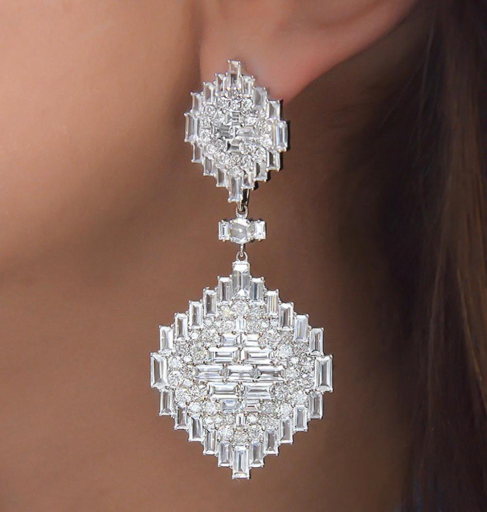 Nam Cho is a fine jewelry designer based in NYC, known for her glamorous designs with an edge. 
These 18 karat white gold, diamond and white sapphire earrings are a perfect example of her unique style.
The hanging earrings are set with 4.00 carats