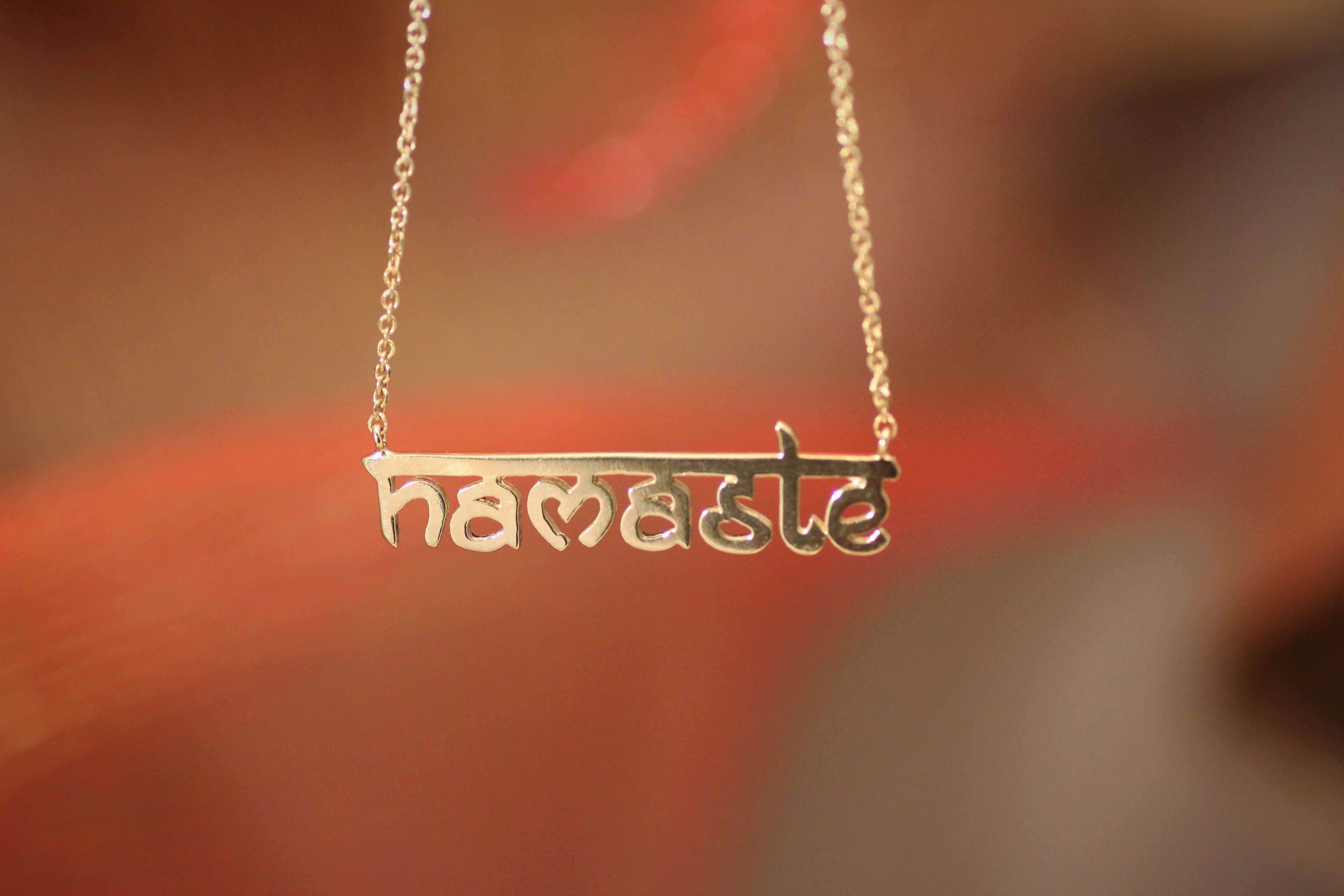 Pendant Necklace inspired by Yoga ''Namaste'', handcrafted in 14Kt Gold.
Namaste is a devout greeting with a wonderful content. By saying this word, you greet that place in your body, where the universe lives. This unique pendant necklace belongs to