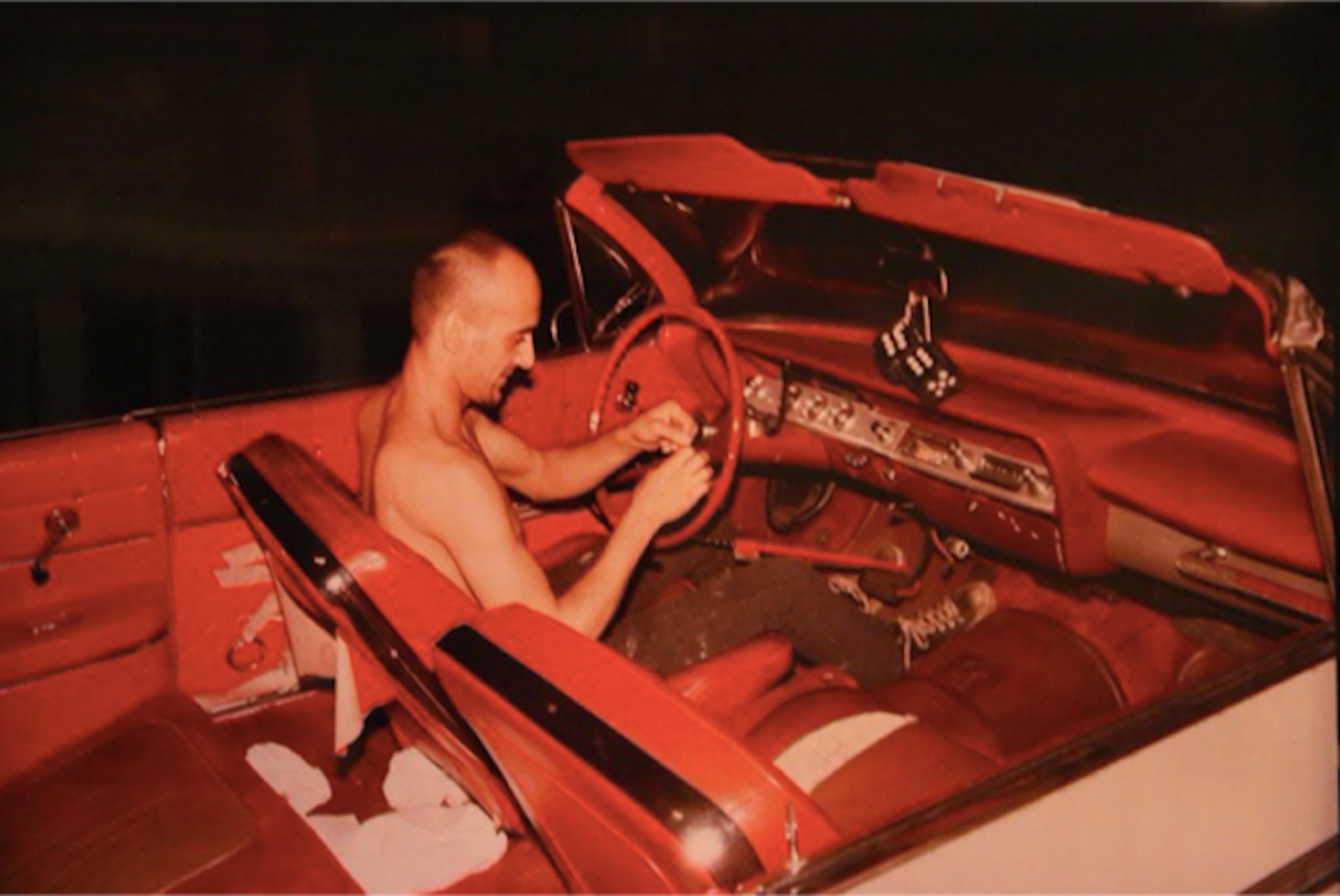 Nan Goldin Figurative Photograph - Bruce in his red car, NYC