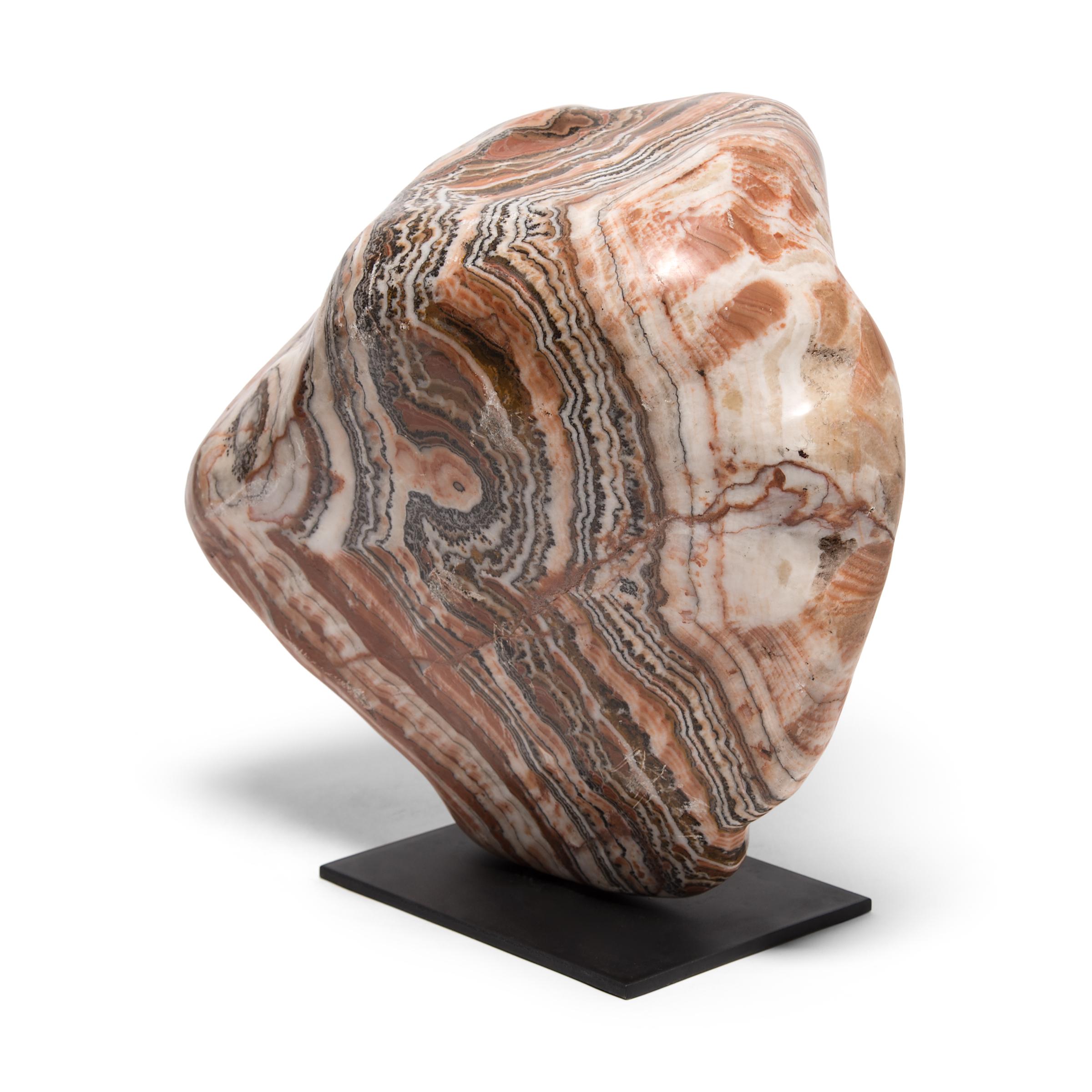 A well-chosen stone is a focal point of both a traditional Chinese garden and a scholar's studio - evoking the complexities of nature and inspiring creative thought. Sourced from China's Henan province, this Nan yang meditation stone swirls with a