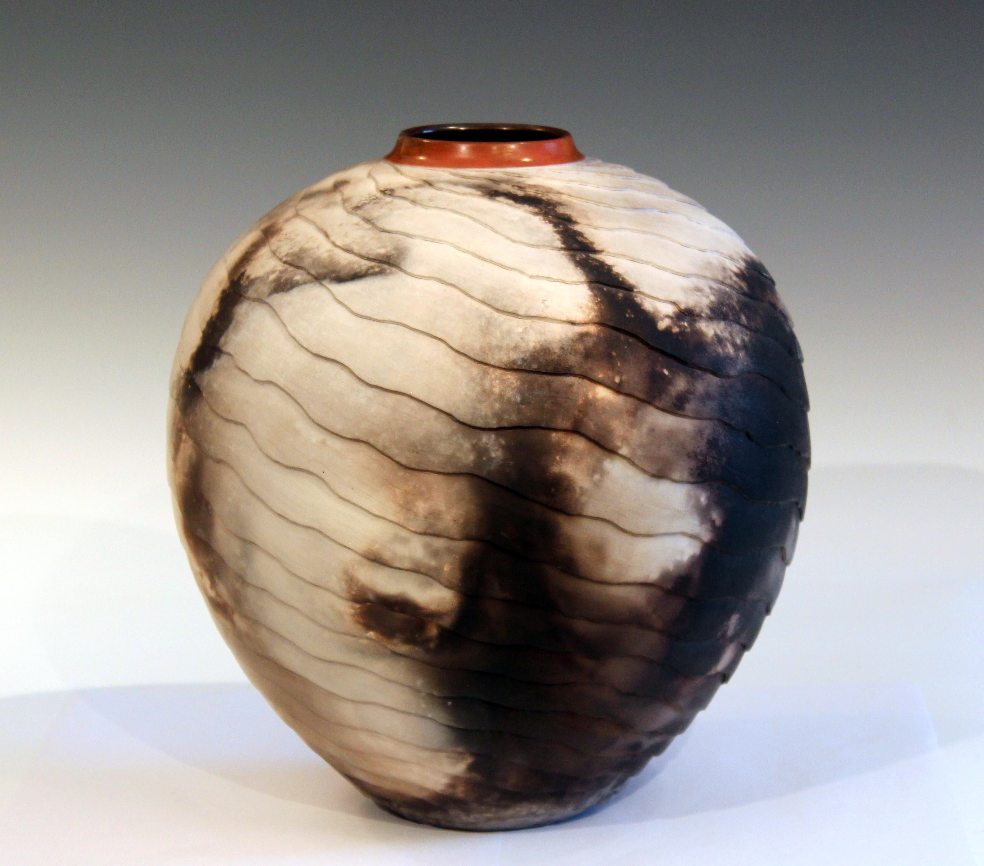 Large Nancee Meeker hand thrown earthenware vase, carved with metamorphic ledges, burnished and smoked. From her 