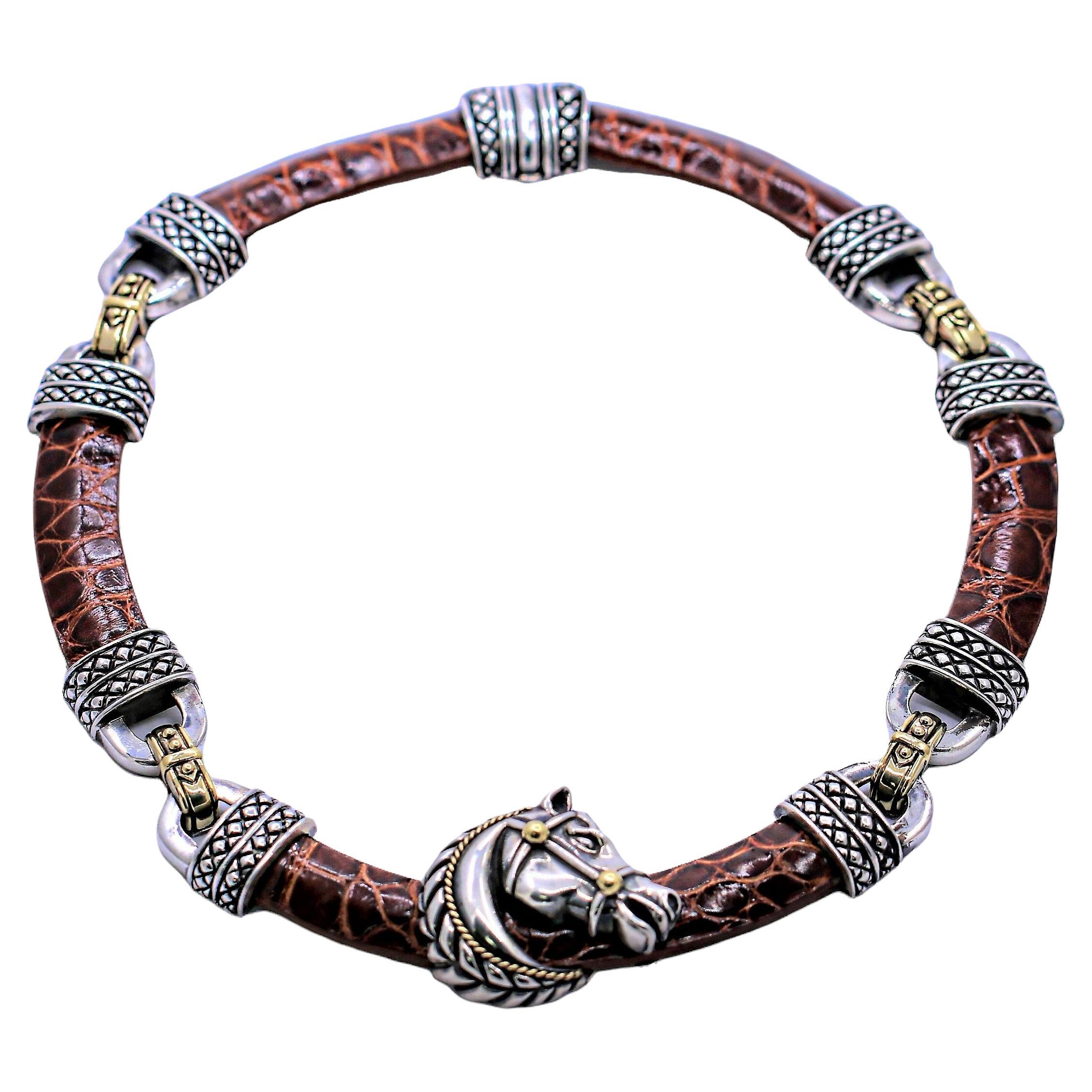This sporty Nancy and David choker necklace features an intricately detailed horse head in profile, made of sterling silver with 18K gold accents at it's center, and with Equestrian motifs throughout. The horse head measures 1  3/8 inch wide by 1 