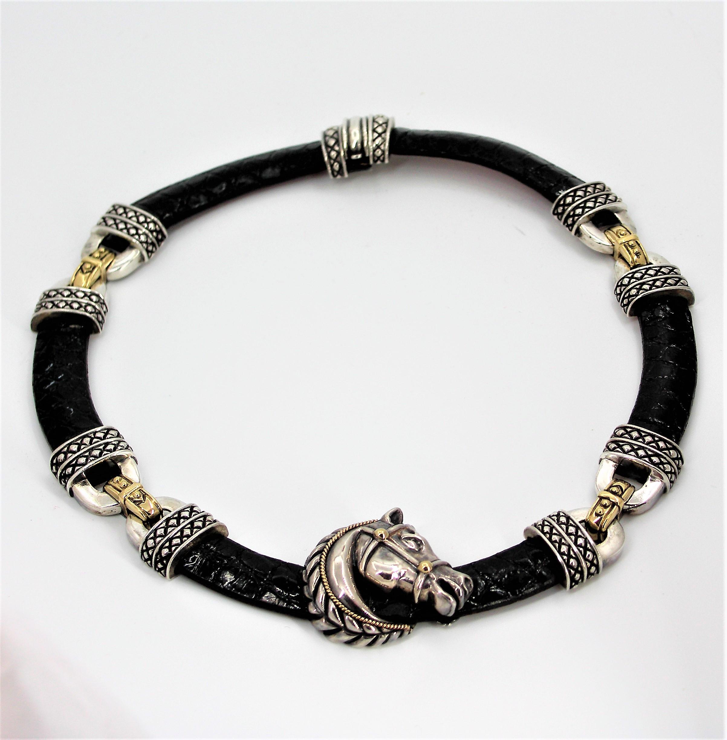 Made by Nancy & David, this black, textured leather necklace has one center, 
large, articulated horse head made of Sterling Silver with 18K yellow gold accents.
The four Sterling Silver stations are accented with 18K yellow gold connecting
links.