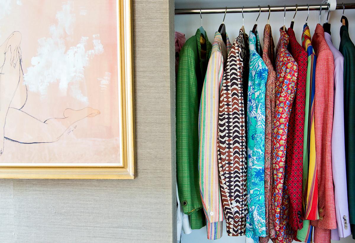 Bob's Closet by Nancy Baron is a 15 x 22 in archival pigment print, available in an edition of 10. This photograph features a closet with many colorful patterned blazers. This photograph is from Nancy Baron's series, Palm Springs: The Good Life.