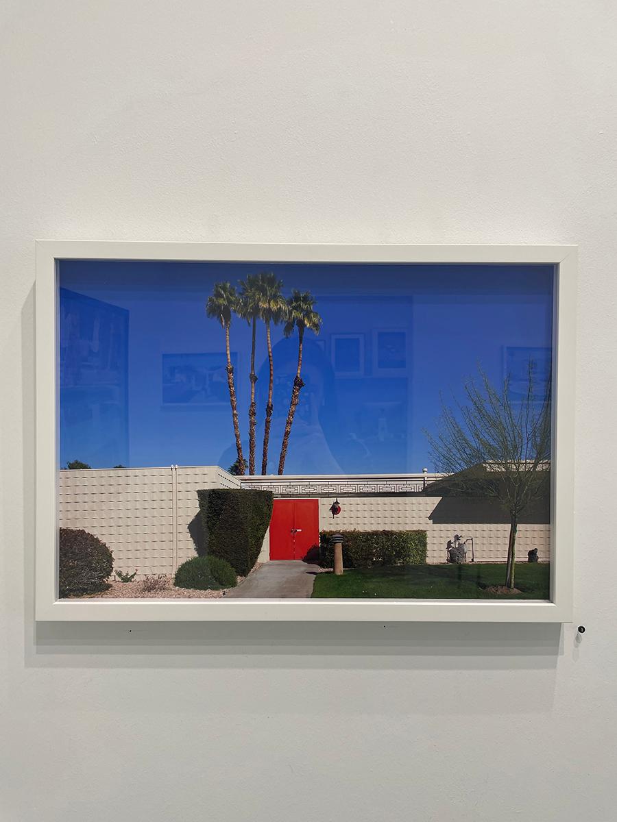 Red Door by Nancy Baron is a 15 x 22 inch archival pigment print, available in an edition of 10. The photograph features the outside of a mid century modern house with a red door, and a group of 4 palm trees. This photograph is from Nancy Baron's