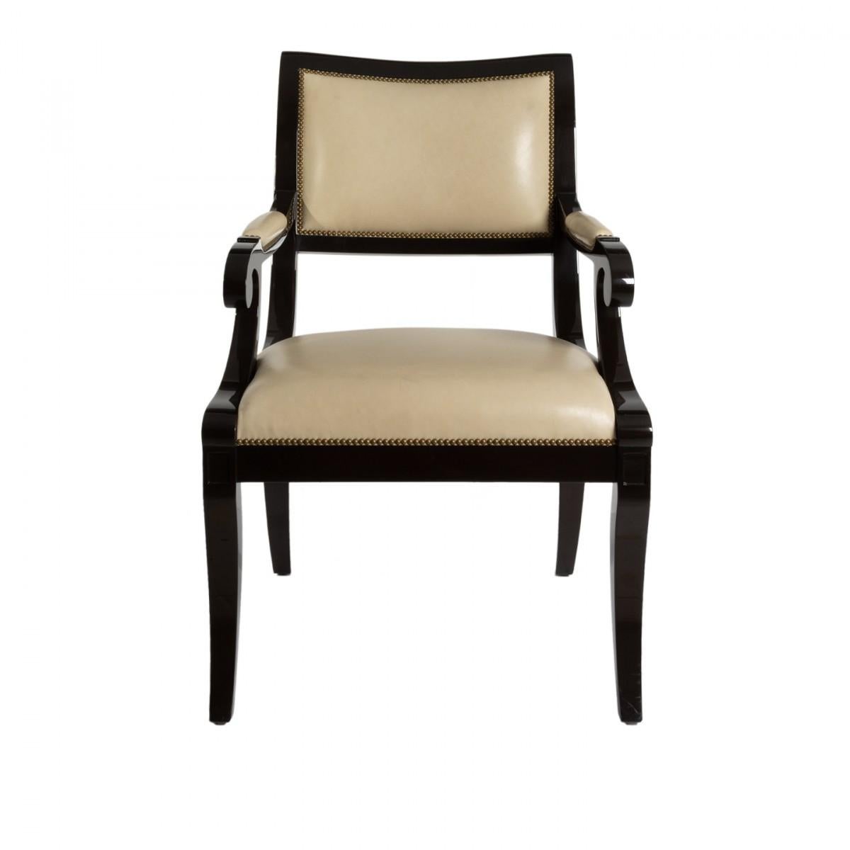 A Nancy Corzine desk chair or armchair with an ebonized frame and nailhead trim, upholstered in cream leather.