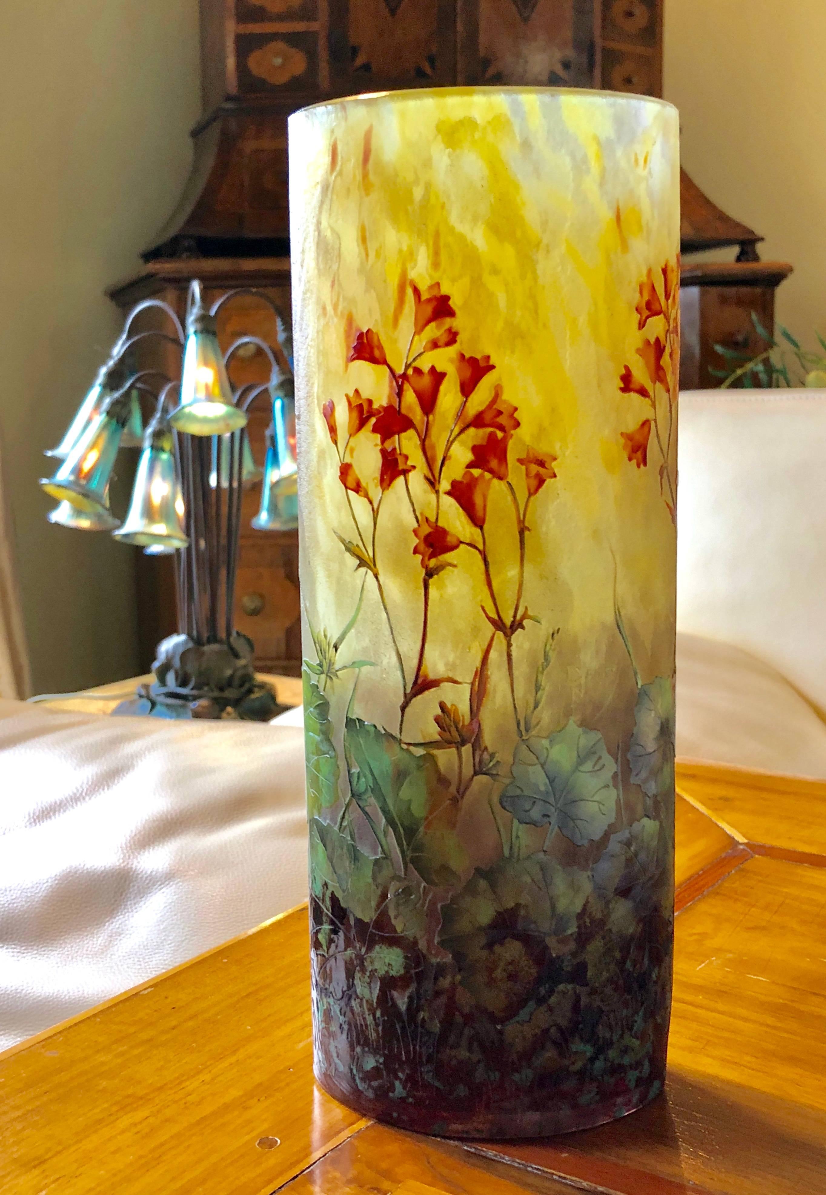 A French Art Nouveau enameled and etched glass vase by Daum, circa 1910.
It is a fine example of the intricate multi layers of colored glass ranging from deep Amethyst on the base to a bright canary yellow on top. The signature is etched in relief