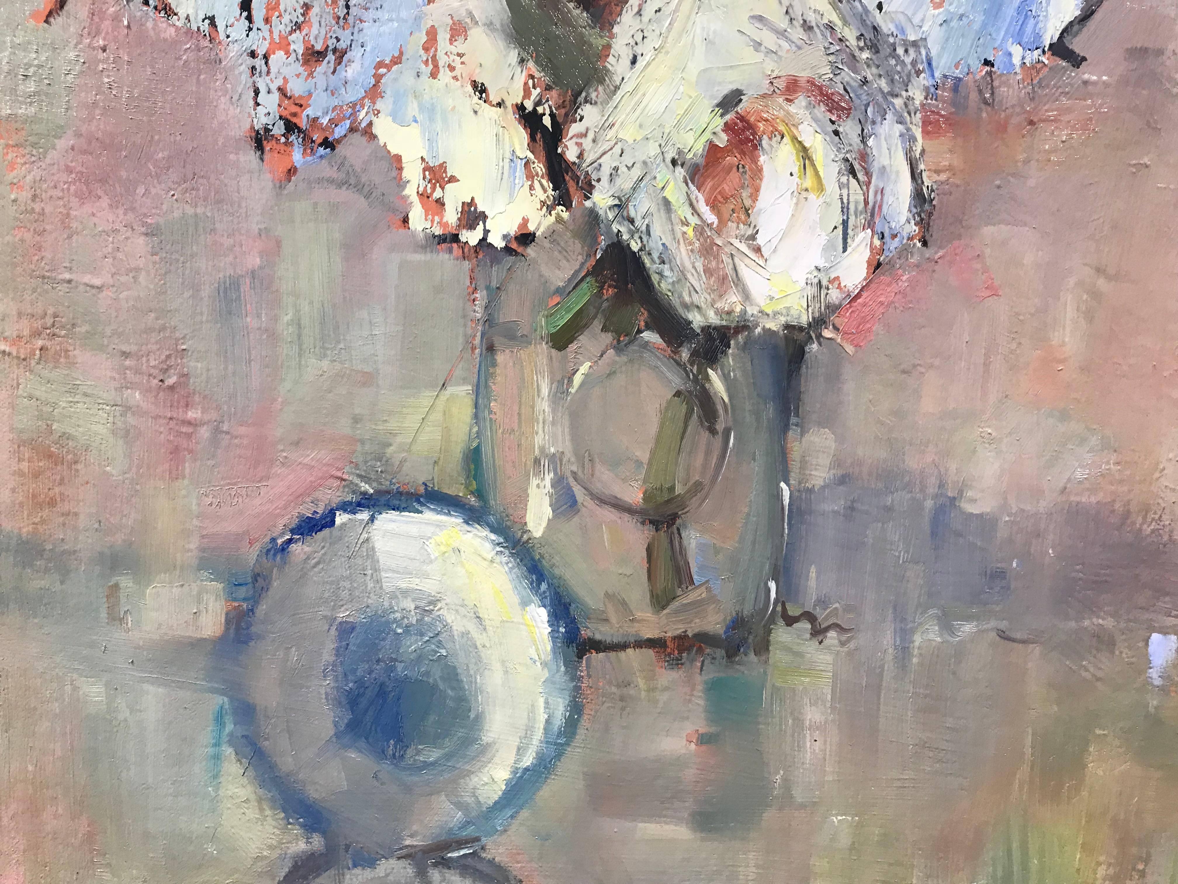 'Revelation' is a framed Impressionist oil on linen board painting created by American artist Nancy Franke in 2018. Franke gives here an elegant rendition of a bouquet of white flowers set inside a glass vase, depicted on a soft pink background. A