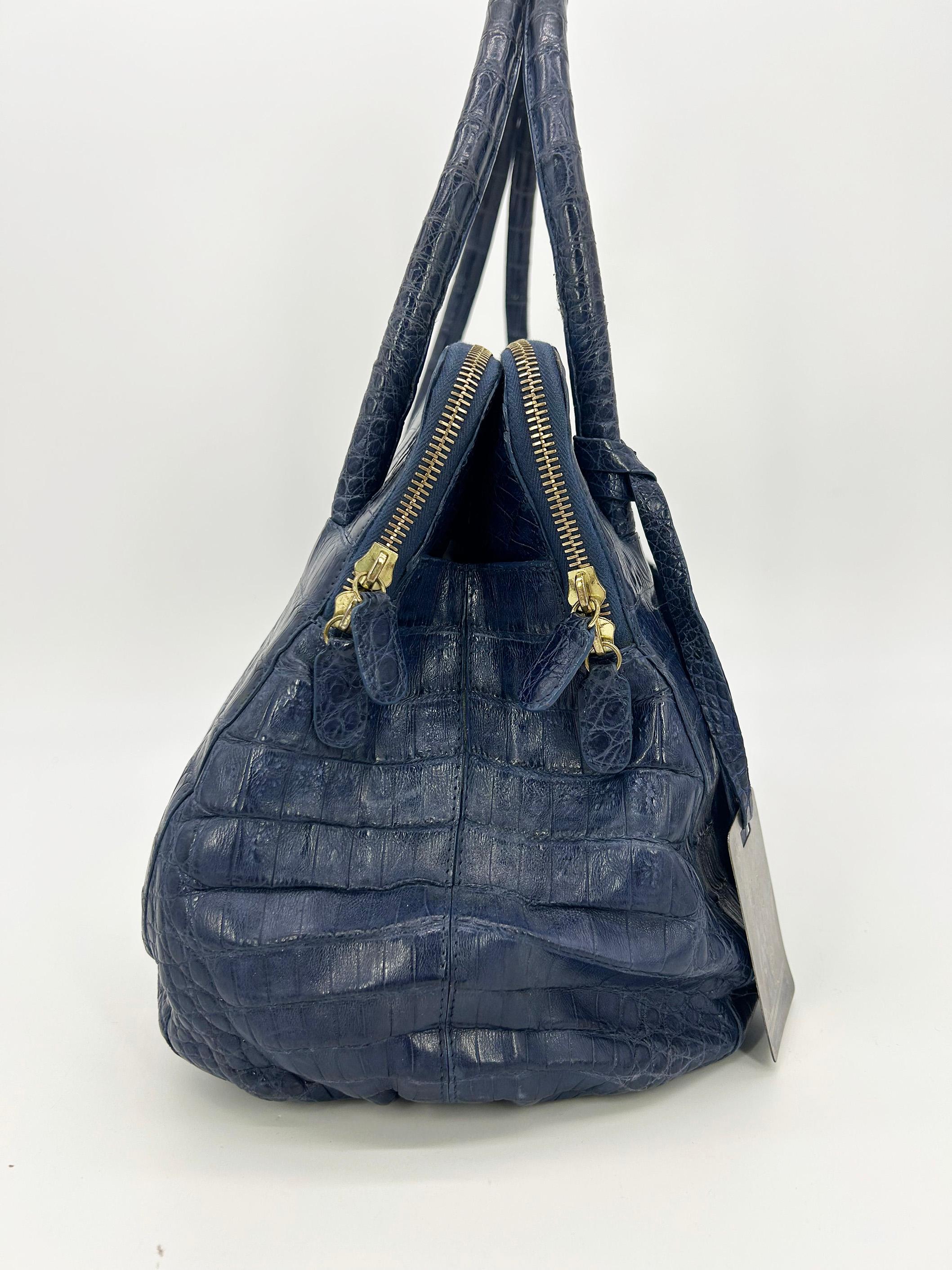 Nancy Gonzales Blue Crocodile Linda Tote en bon état. Le cuir de crocodile signature dans un magnifique bleu profond dans le design classique de Linda. Deux poches extérieures fendues sur le devant qui sont presque cachées en apparence mais qui
