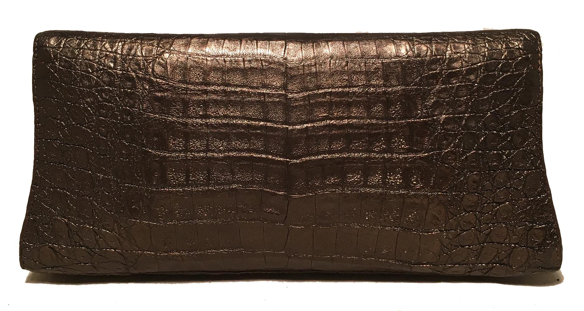 Nancy Gonzalez Bronze Brown Crocodile Clutch in very good condition. Bronze, metallic brown crocodile leather exterior with a magnetic top flap closure. Beige suede interior with one side slit pocket. Overall very good condition. No stains, smells
