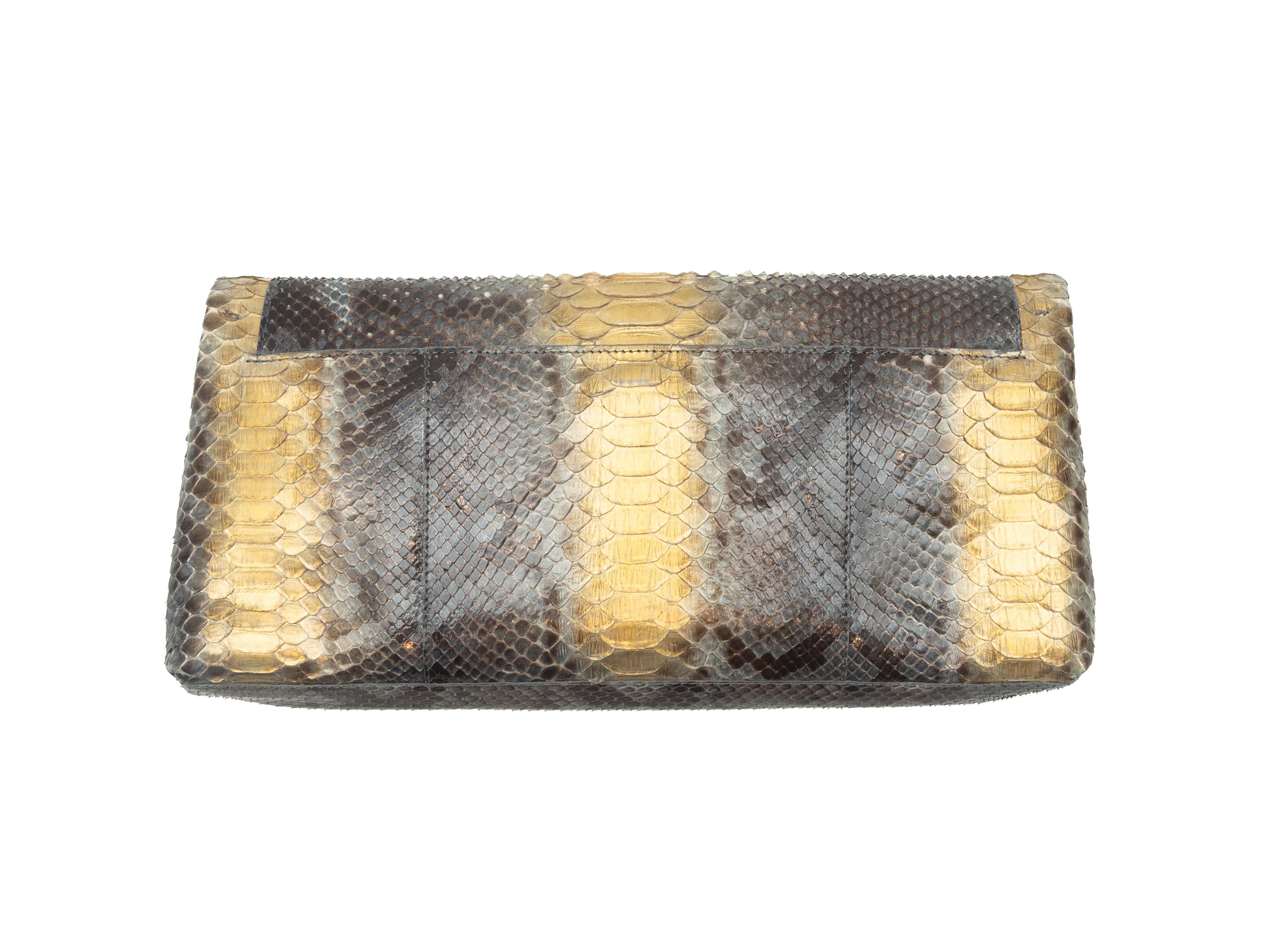 Product details: Brown and metallic gold python clutch by Nancy Gonzalez. Interior zip pocket. Flap closure at front. 11
