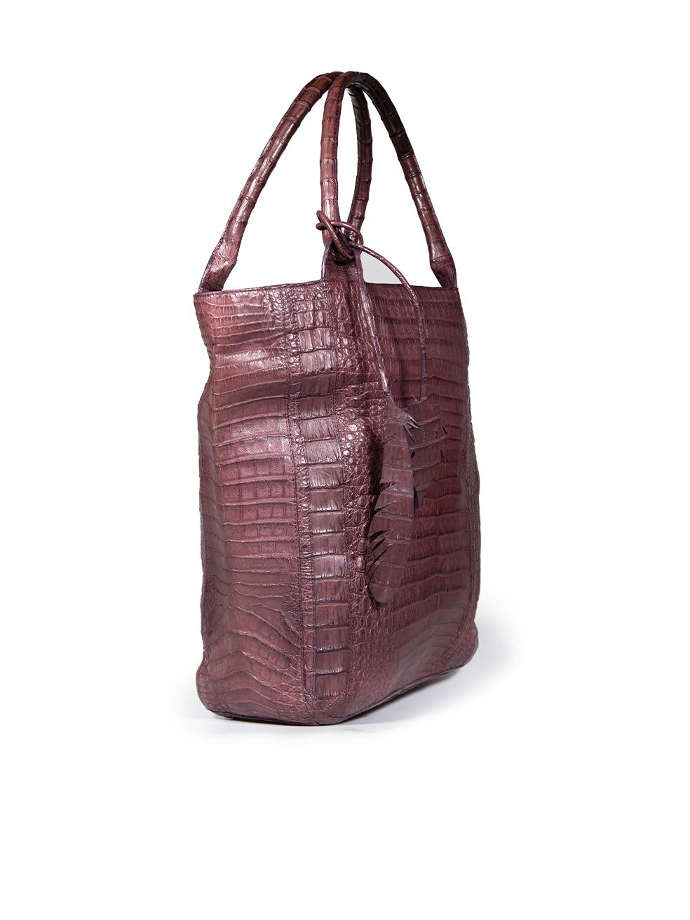 CONDITION is Very good. Minimal wear to the tote bag is evident. One mark to the lining on the back of this used Nancy Gonzalez designer resale item.
  
  Details
  
  
  Burgundy 
  
  Crocodile
  
  Tote bag
  
  Medium
  
  2x Top handles
  
 