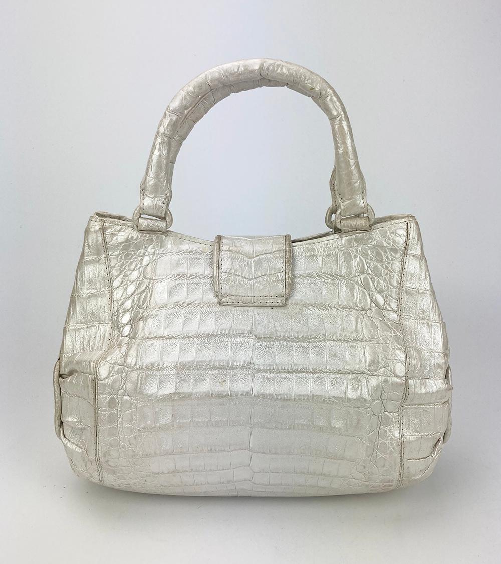 Nancy Gonzalez Iridescent Peal White Crocodile Handbag in excellent condition. Iridescent pearl crocodile exterior with top double handles. Top strap magnetic snap closure opens to a light blue suede interior with one side slit pocket. Excellent