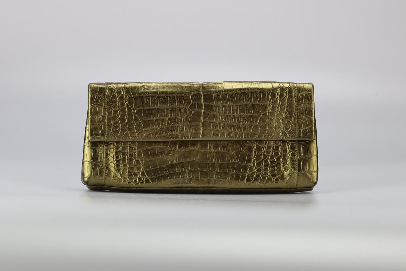 Nancy Gonzalez Metallic Crocodile Clutch. Gold. Magnetic fastening - Front. Does not come with - dustbag or box. Height: 5.2 in. Width: 11.1 in. Depth: 1.5 in. Condition: Used. Very good condition - No signs of wear; see pictures.