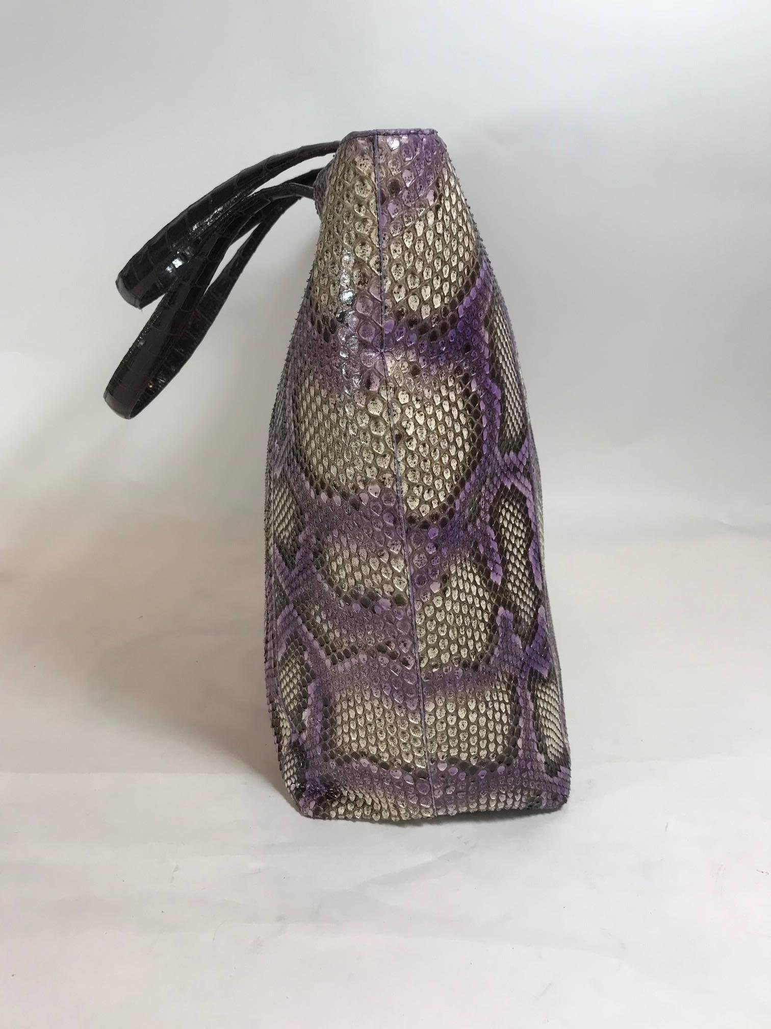 Purple, brown and off white python. Dual top handles. Magnetic top closure. Sand color suede interior. Three interior opened pockets. One interior zippered pocket.
