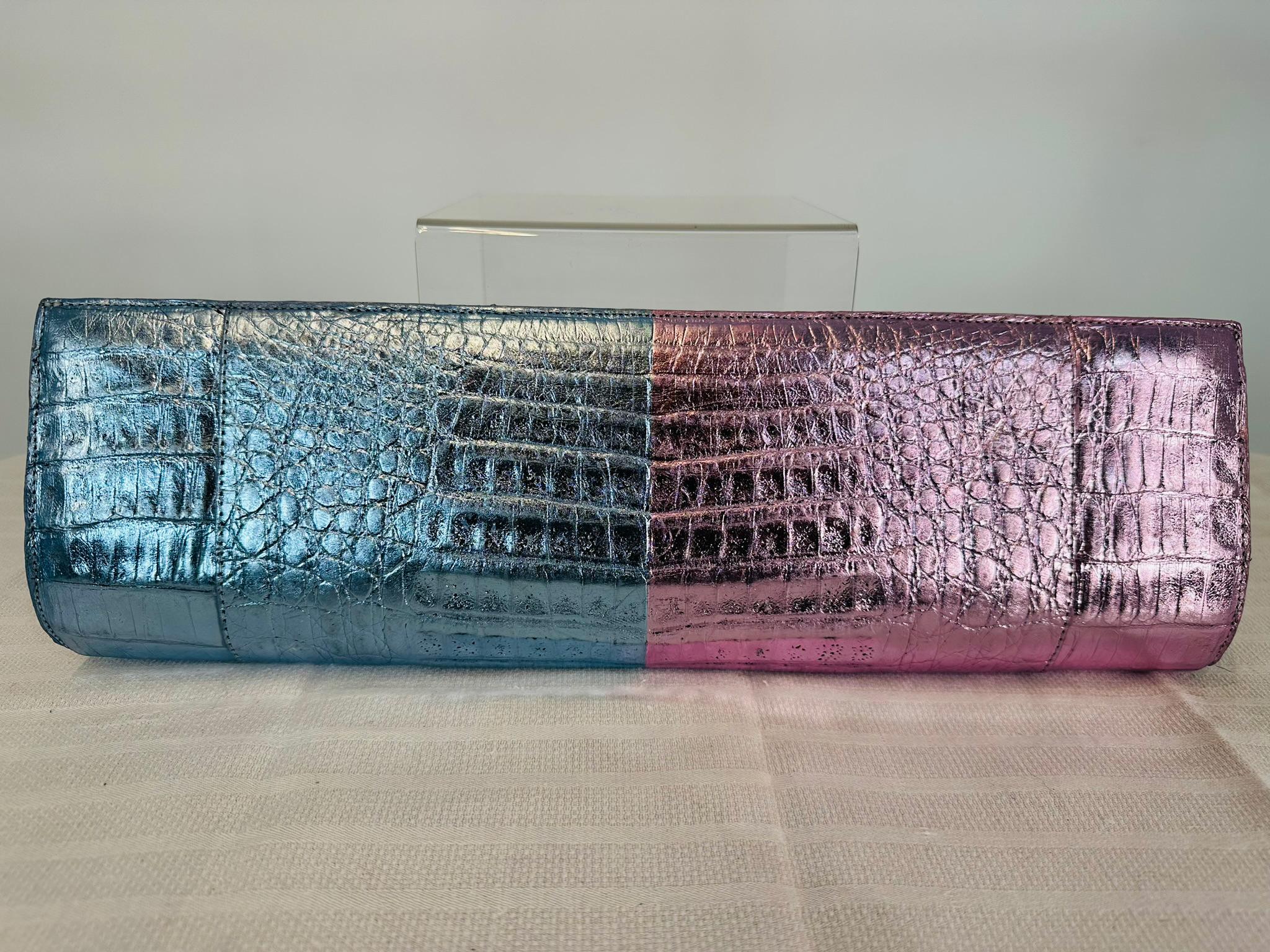 Nancy Gonzalez metallic pink & blue crocodile, long clutch hand bag. Sleek, modern clutch perfect for any special event. Long clutch closes with a magnetic clasp. The bag will hold cosmetics, brush or comb,
mirror pen but not an I Phone. This bag is