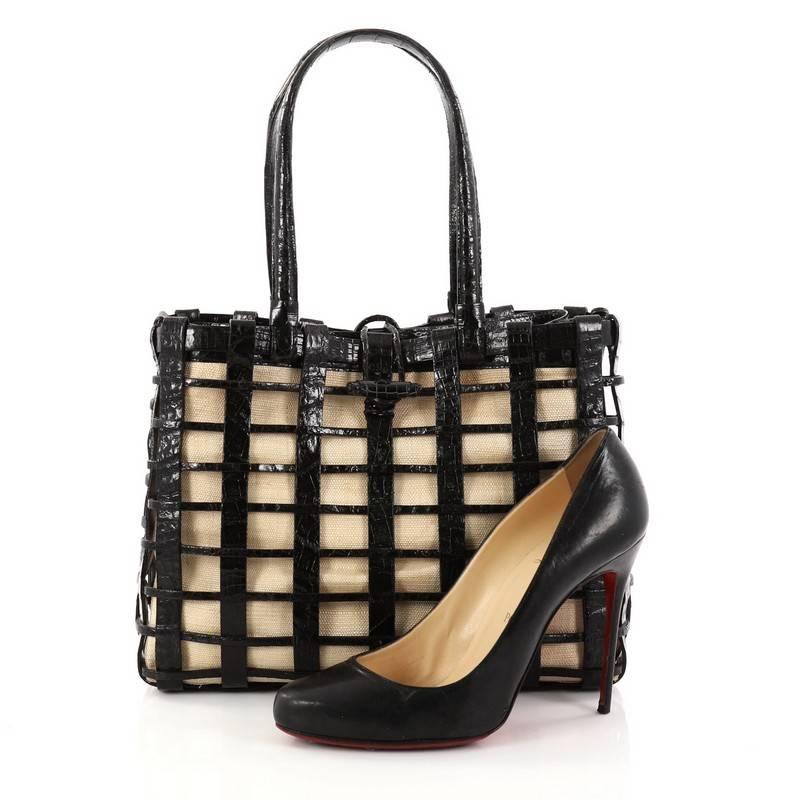 This authentic Nancy Gonzalez Toggle Tote Woven Crocodile Large mixes exotic luxury with casual, deconstructed styling made for everyday or travel use. Crafted from genuine black woven crocodile skin, this tote features impeccably crafted loose
