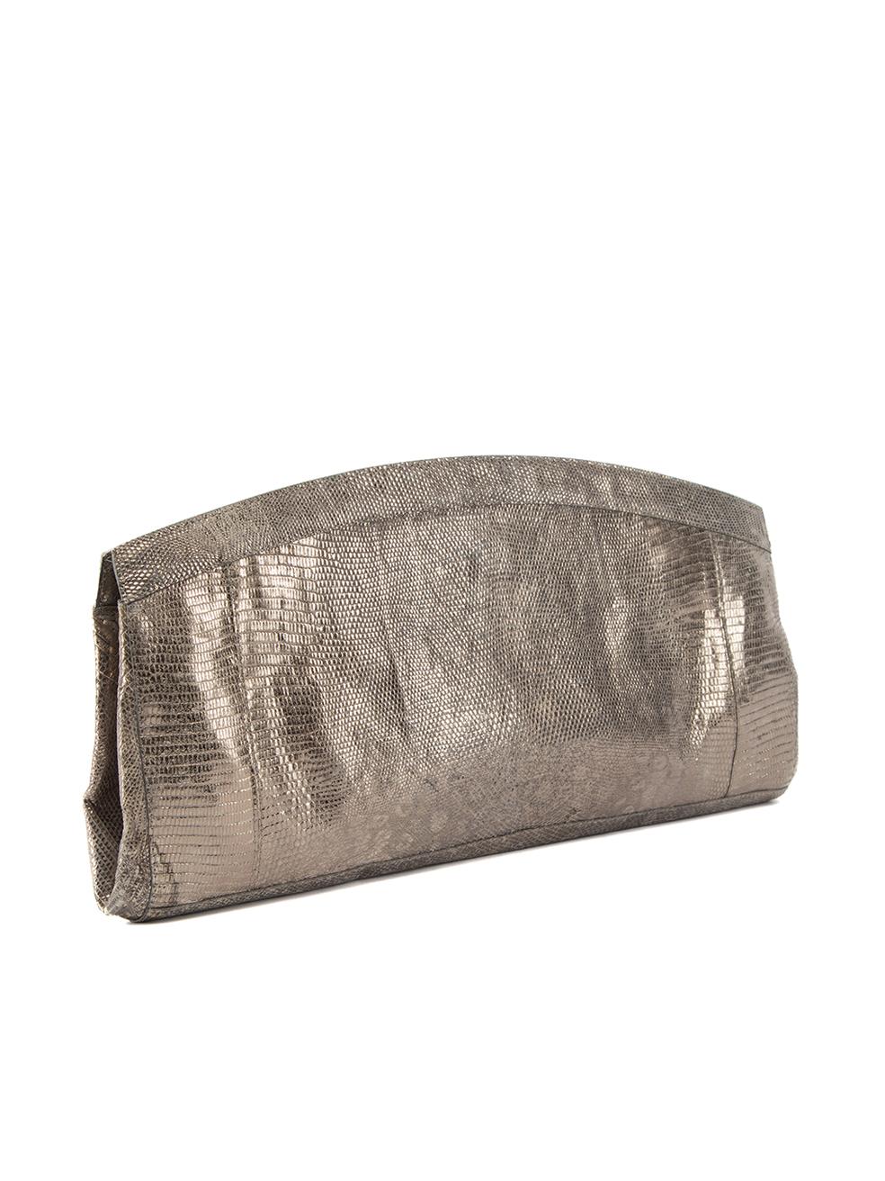 CONDITION is Very good. Minimal wear to clutch is evident. Minimal wear to the metallic exterior, however there are visible stains to the suede interior where makeup stain and other marks can be seen on this used Nancy Gonzalez designer resale item.