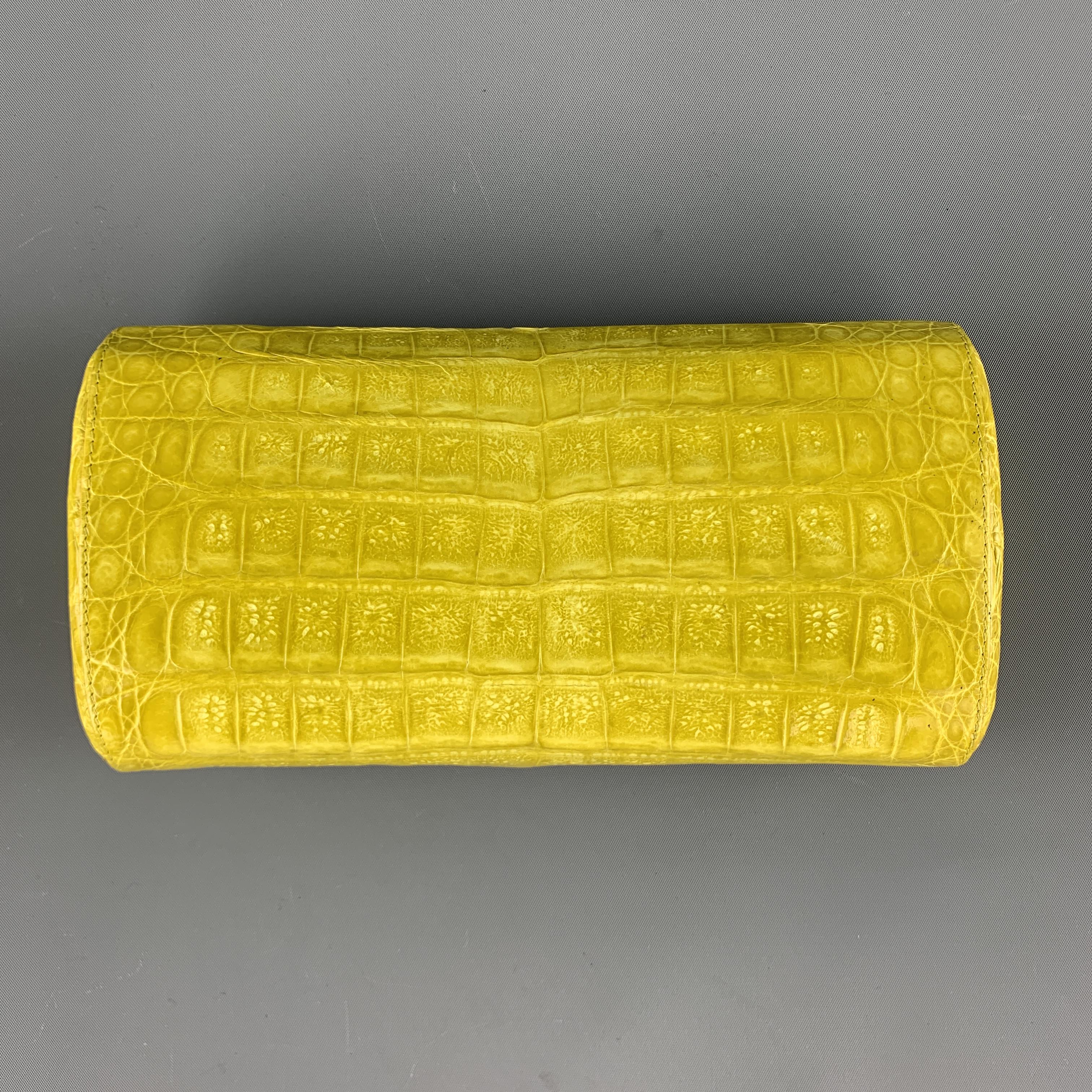 NANCY GONZALEZ Handbag Clutch comes in a yellow tone in a crocodile leather material, with a magnetic closure and a beige silk lining.
 
Excellent Pre-Owned Condition.
 
Measurements:
 
Length: 8 in.
Width: 2 in.
Height: 4 in.