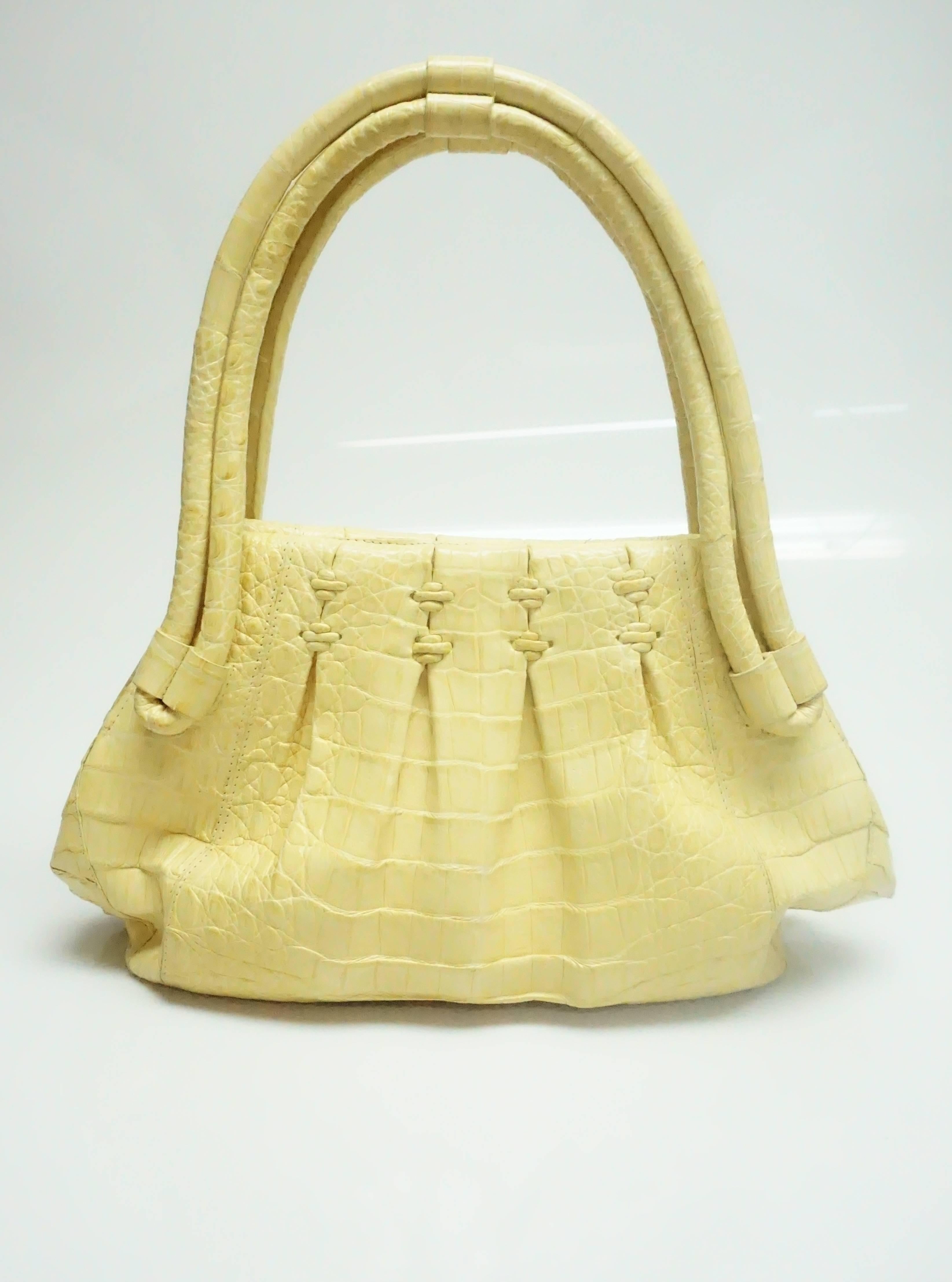 Nancy Gonzalez Yellow Crocodile Shoulder Handbag  This beautiful unusual style of bag is box pleated with two double straps. It has a magnetic closure and it has been barely used. This bag is in excellent condition.
Measurements
Height: 8.5