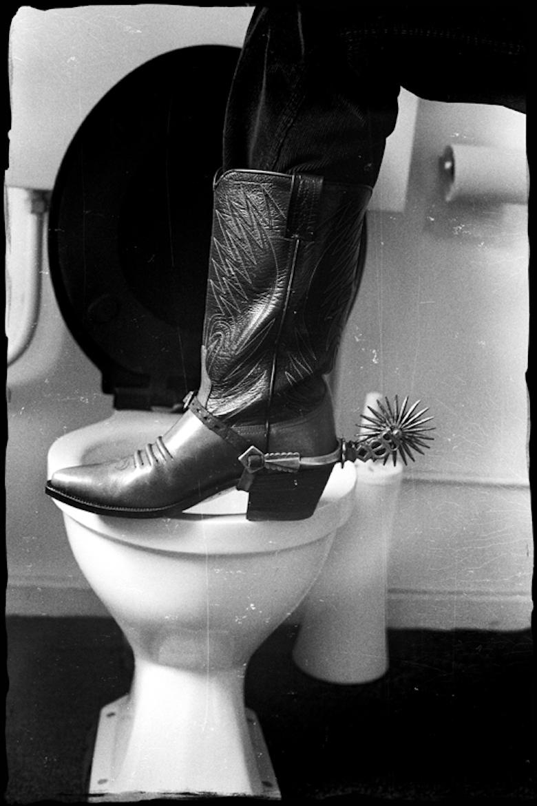 Nancy Lee Andrews Black and White Photograph - The Beatles - Ringo Starr Boots and Spurs on the toilet seat 