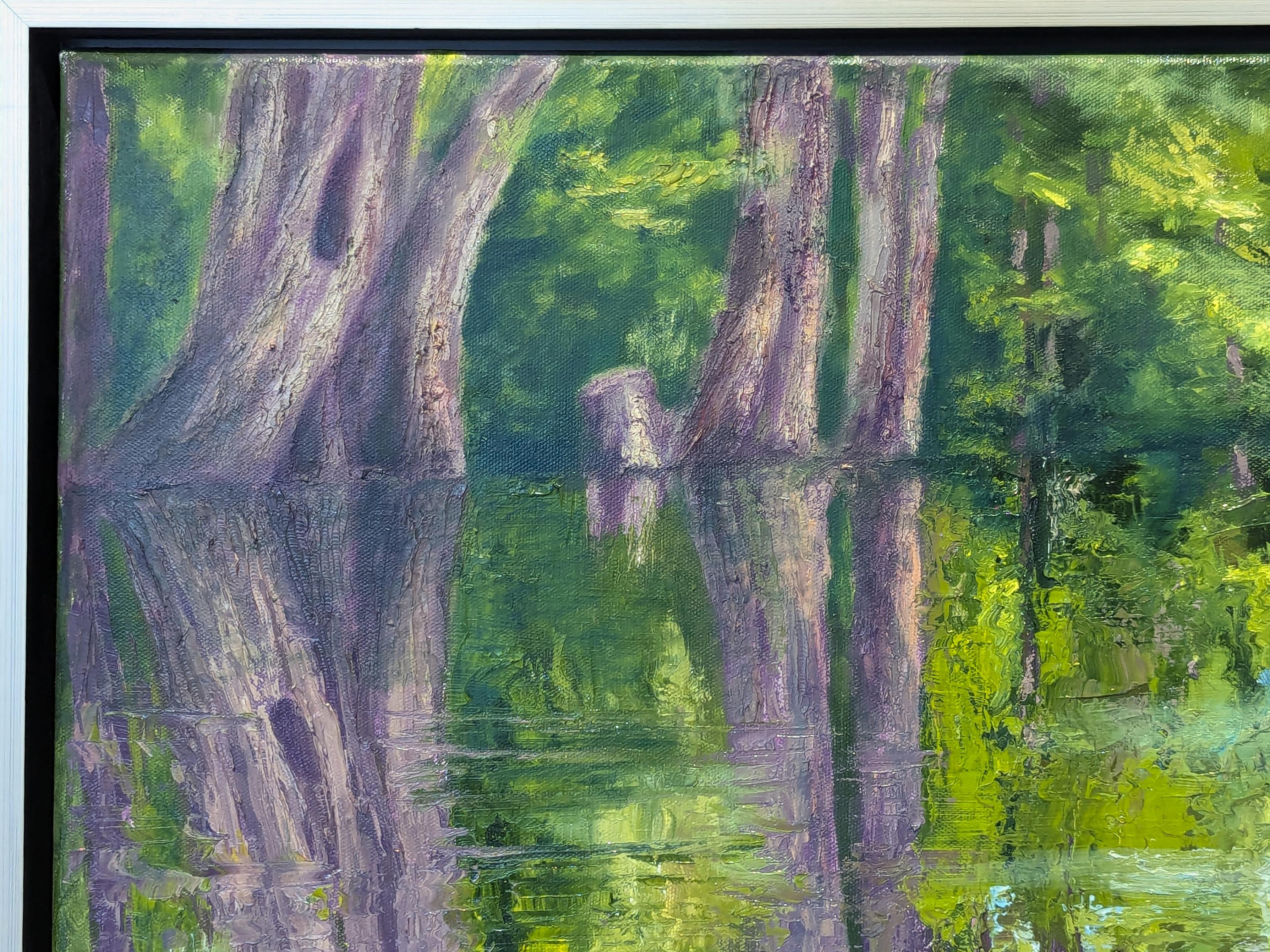 Rich blue and green toned naturalistic landscape painting by Houston based artist Nancy Paris Pruden. The work features a serene scene of water flowing through the trees of a cypress creek. Currently hung in a silver floating frame.

Dimensions