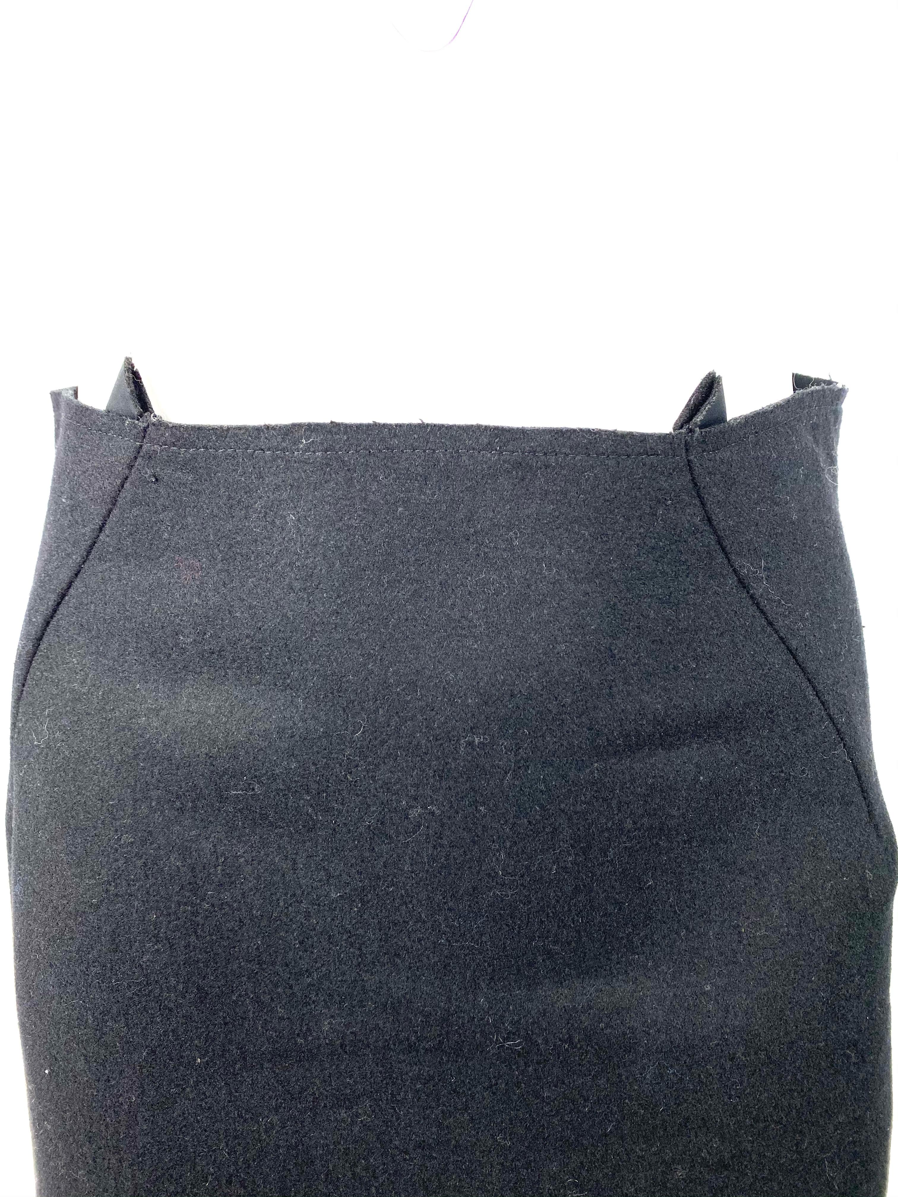 Product details:

Black wool skirt in medium size designed by Nancy Stella Soto in the United States. The skirt features pencil style with geometric square cut out design on the bottom and concealed rear zip closure, mid length.