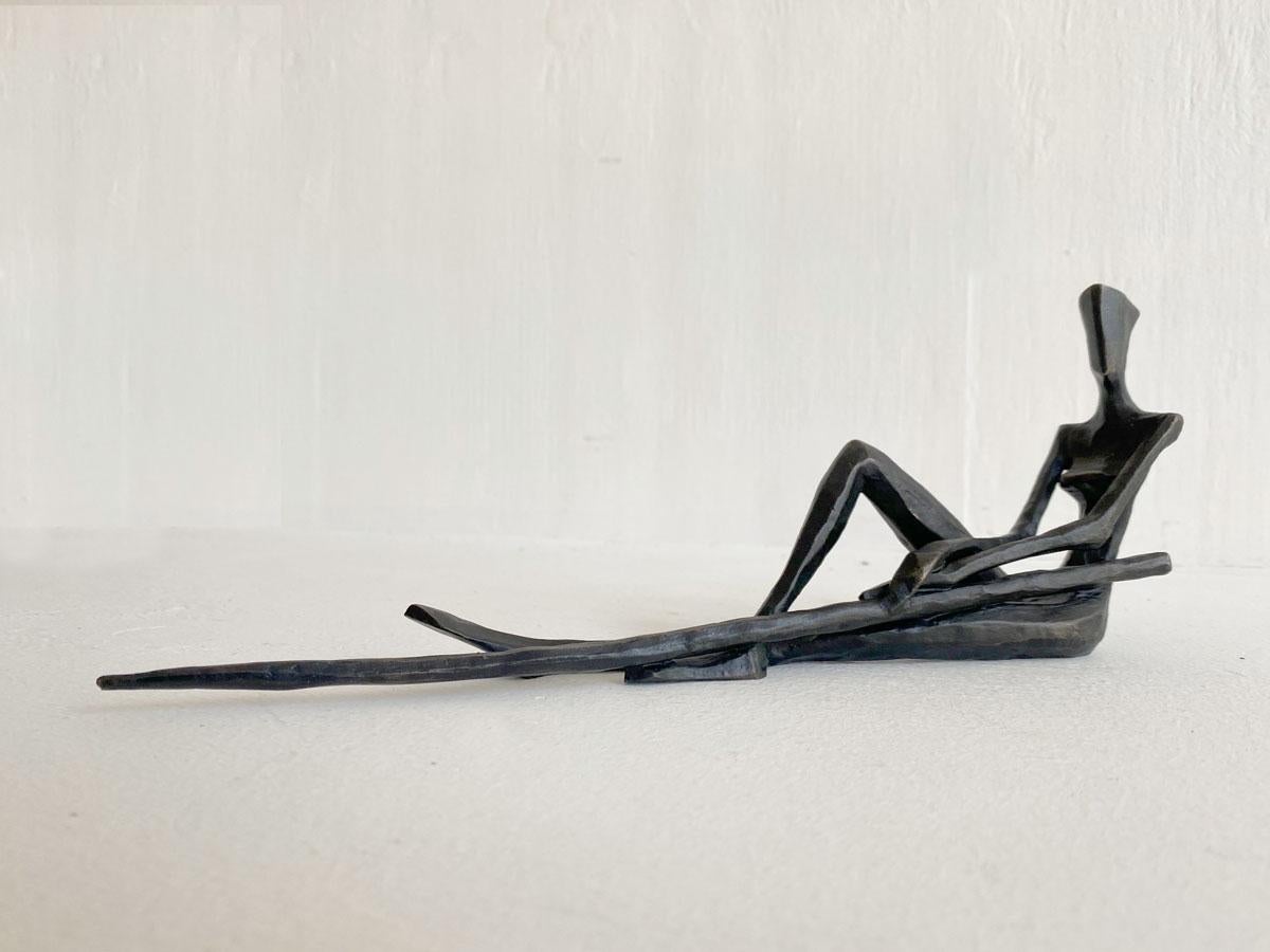 Nando Kallweit's Juliana II depicts a reclining female figure with a spear executed in a stylized, abstract manner. The elongated form captures a sense of serene relaxation and introspection, the weapon a sense of preparedness to meet the challenges