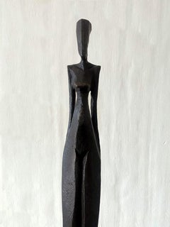 Kathy by Nando Kallweit. Tall, elegant bronze sculpture of human figure.