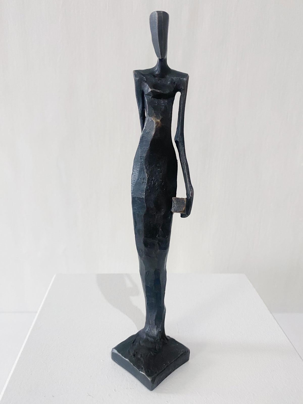 Woman with Dice is an elegant figurative bronze sculpture by Nando Kallweit.

Modelled on modern youthful postures but with a nod to the importance of heritage through the stylised Egyptian-influenced head. A lovely piece on its own or with a group