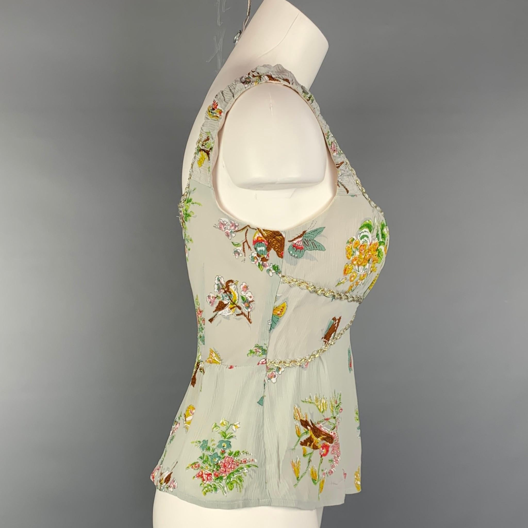 NANETTE LEPORE blouse comes in a multi-color floral silk featuring a ruched style, metallic trim, and a back zipper closure.

Very Good Pre-Owned Condition.
Marked: 4

Measurements:

Bust: 30 in.
Length: 13 in. 