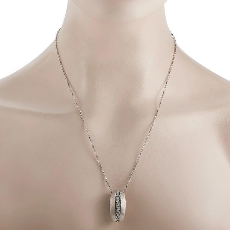 This necklace from Nanis features a beautiful display of contrasting colors and textures. On this piece’s commanding pendant - which measures 1.25” long and .5” wide - you’ll find a series of white and black diamonds with a total weight of 0.85