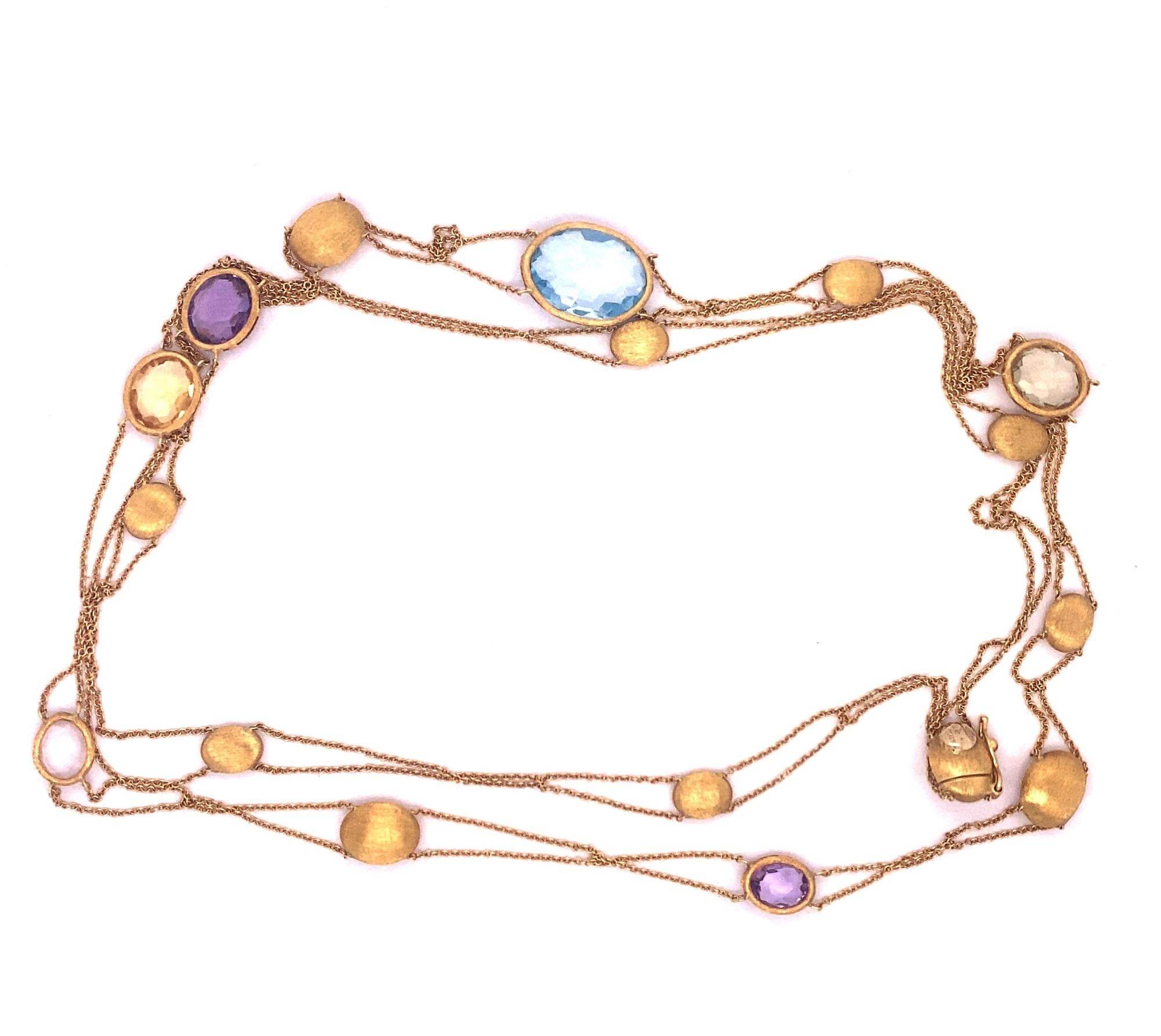 This is a beautiful long chain necklace with topaz, amethyst and citrine stations in 18k yellow gold by important Italian designer Nanis. The necklace has 11 brushed polish finished beads and 6 faceted gemstone sections. Necklace is marked Nanis