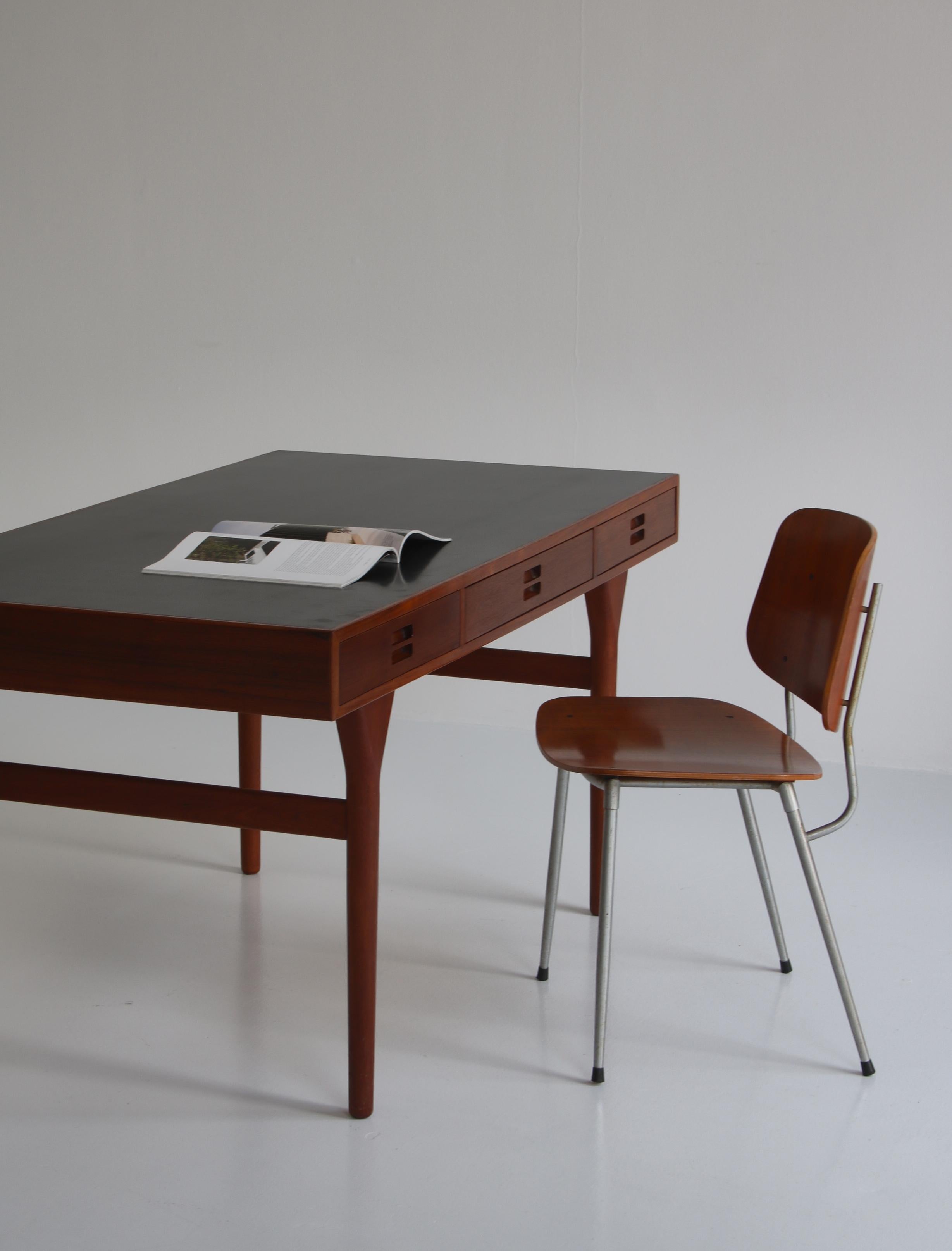 Freestanding vintage Nanna Ditzel desk in teakwood with three integrated drawers. Designed in 1955 and executed at cabinetmaker Søren Willadsen, Denmark. Original custom made piece with hard black 