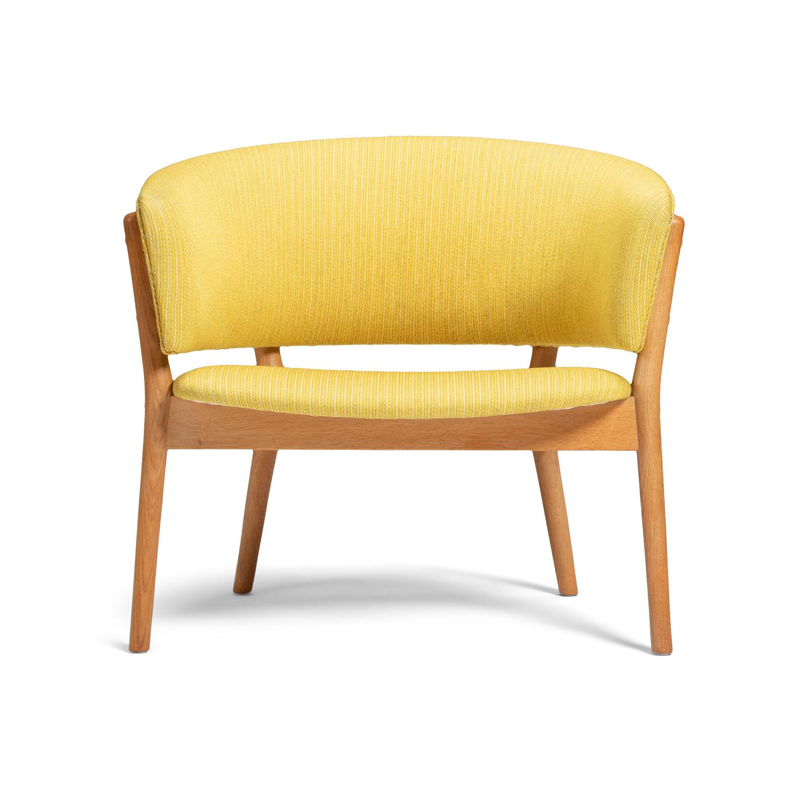 A lovely easy chair with an exposed frame in solid oak, upholstered in original yellow textile. 
Designed by Nanne Ditzel in 1952. Made by cabinetmaker Søren Willadsen, Denmark.