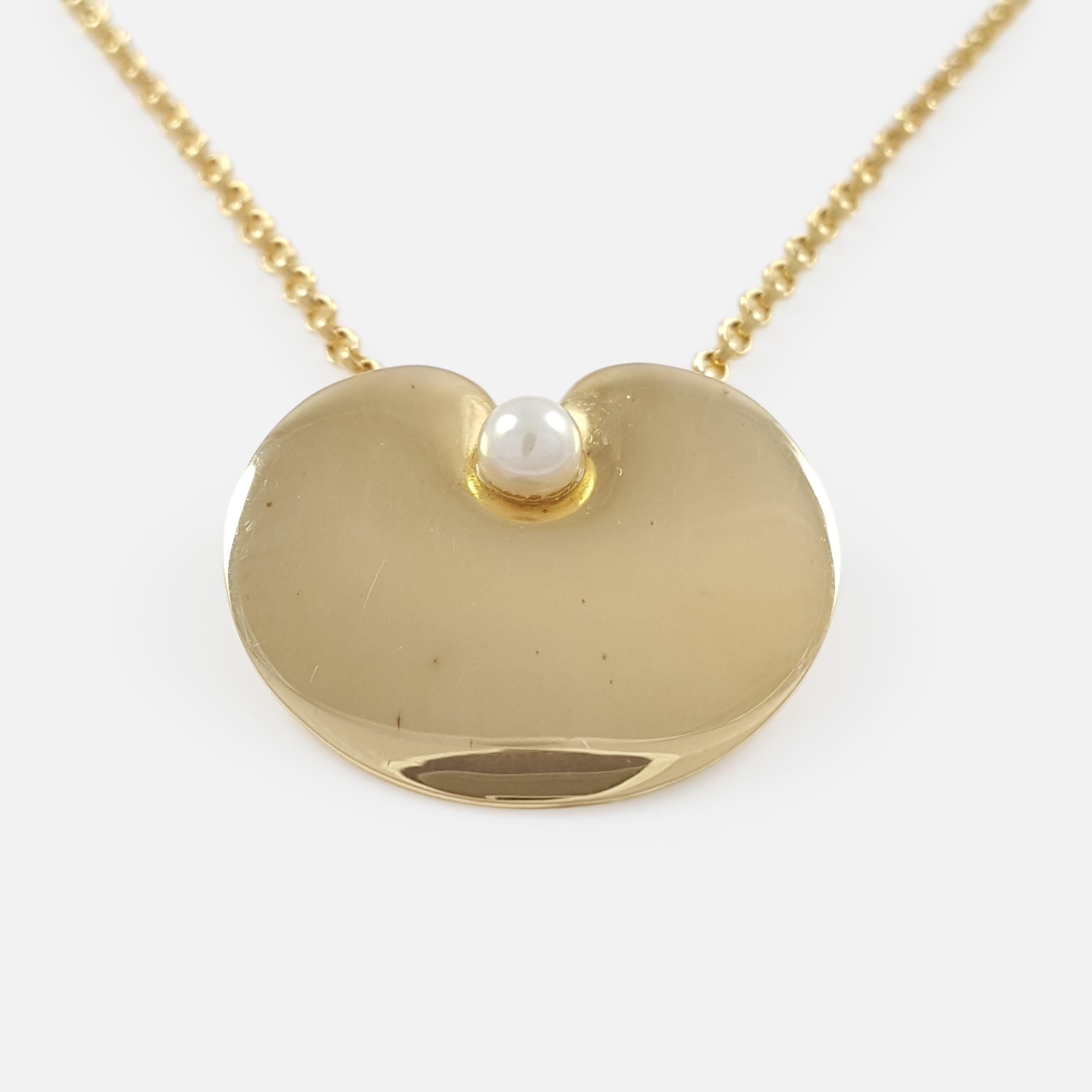 Item: - A superb Georg Jensen 18 karat yellow gold & pearl pendant with original chain. The pendant is designed by Nanna Ditzel for Georg Jensen. Stamped Georg Jensen within dotted oval mark, '750', '1999', 'ND', and 'Denmark'.  The pendant and
