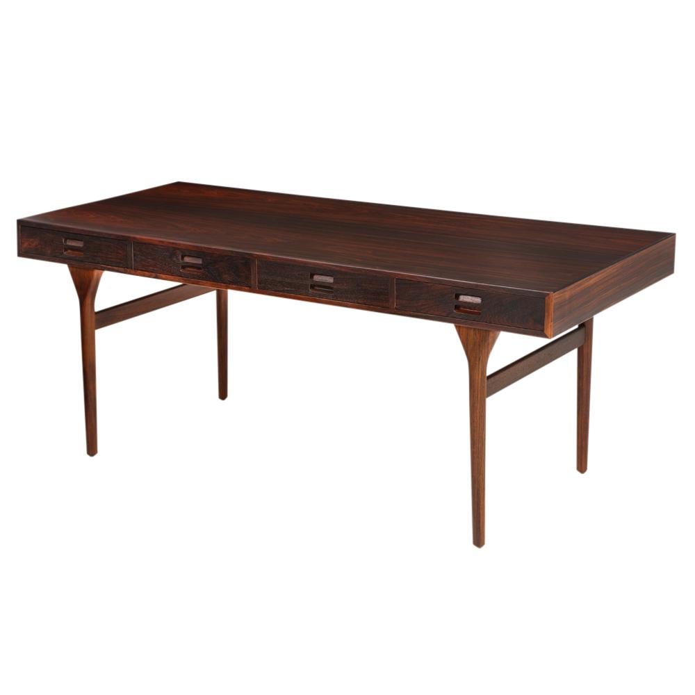 Nanna & Jorgen Ditzel are responsible for some of the most innovative Scandinavian mid-century designs. This desk is a fine example, simple in it's design and incredibly functional with it's storage and large desktop. The added beauty of the