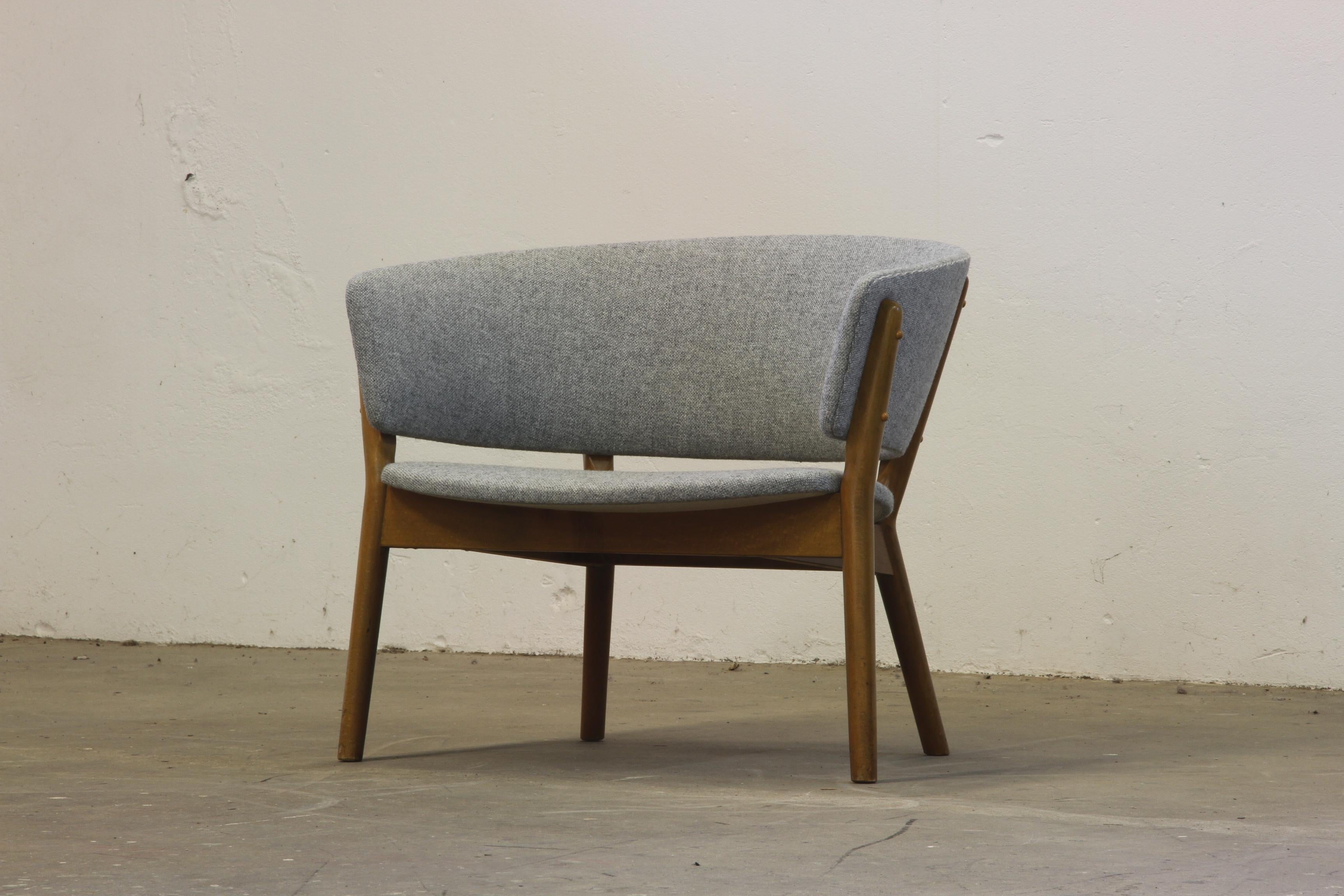 Villadsen in the early 1950s, is a timeless piece of mid-century design. Made from oak with a darker grain, this compact chair features a strong curve, creating an open and inviting presence.

Expertly restored by Denmark’s finest craftsmen, it