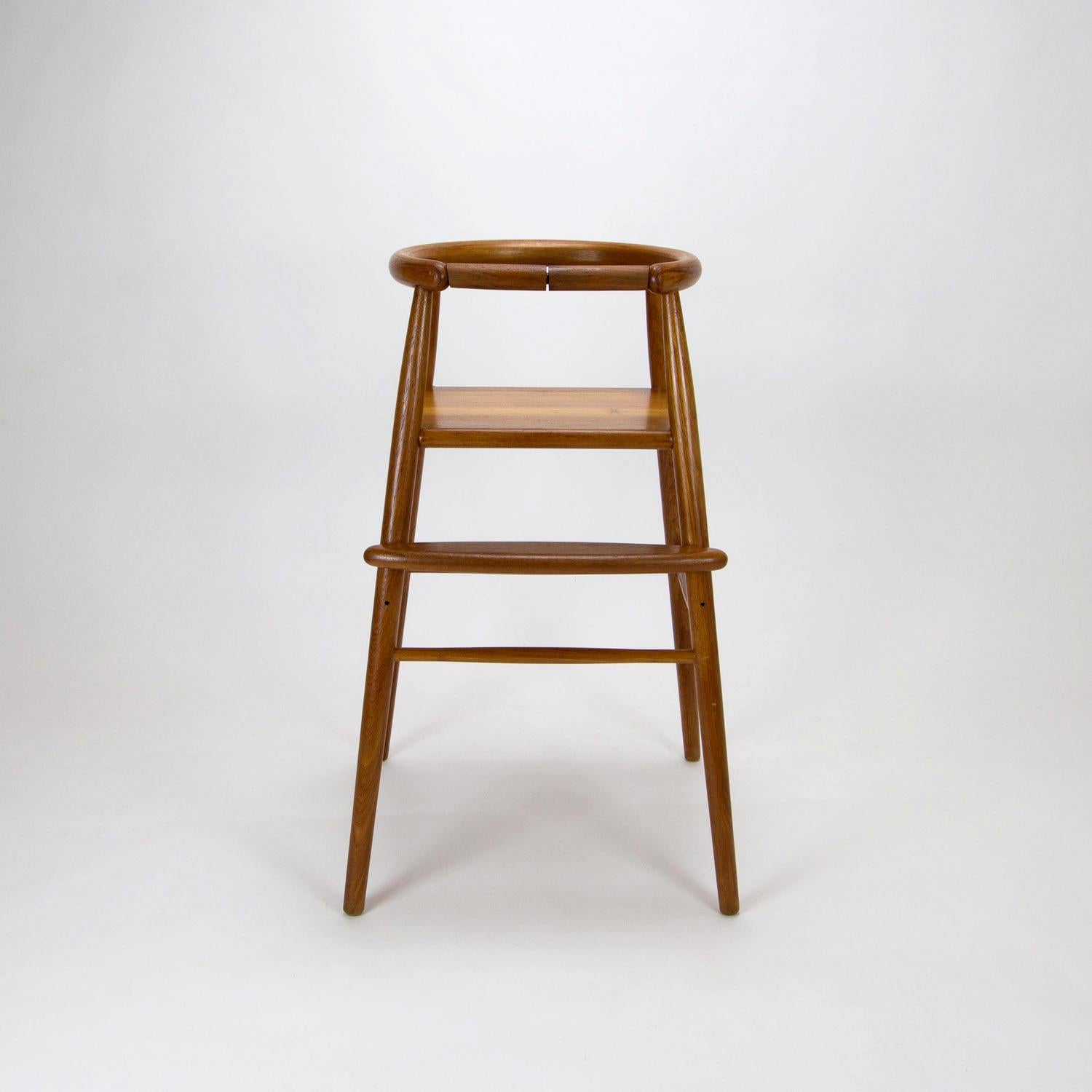 Nanna Ditzel’s iconic model 115 children’s high chair in solid teak by Trip Trap, Denmark, 1970s. Seat height 53cm, height adjustable footrest and removable safety bar.