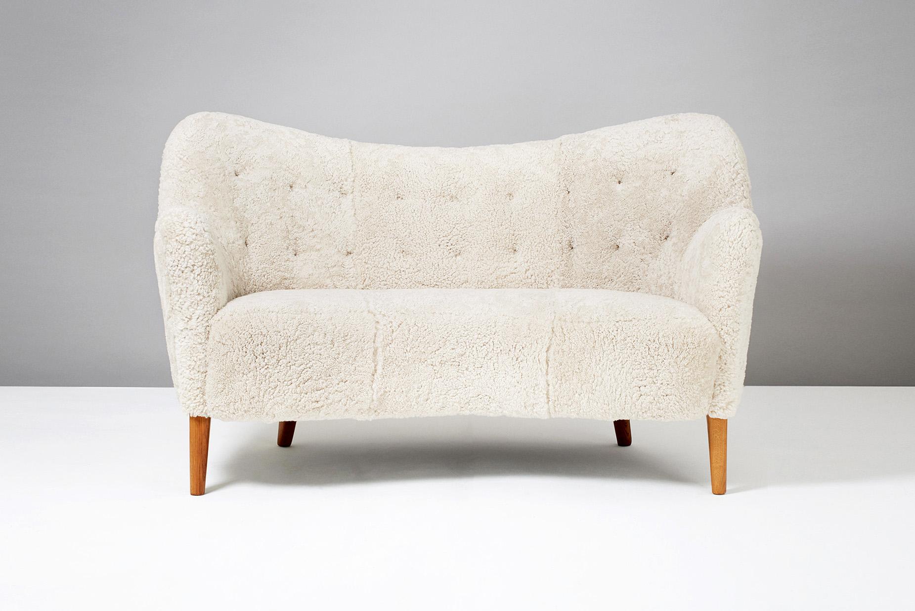 Nanna Ditzel (attributed), Model 185 Sofa, 1952

Rarely seen curved love seat sofa from Danish cabinetmakers Slagelse Mobler. Attributed to Nanna Ditzel. Oiled oak legs and new sheepskin upholstery.