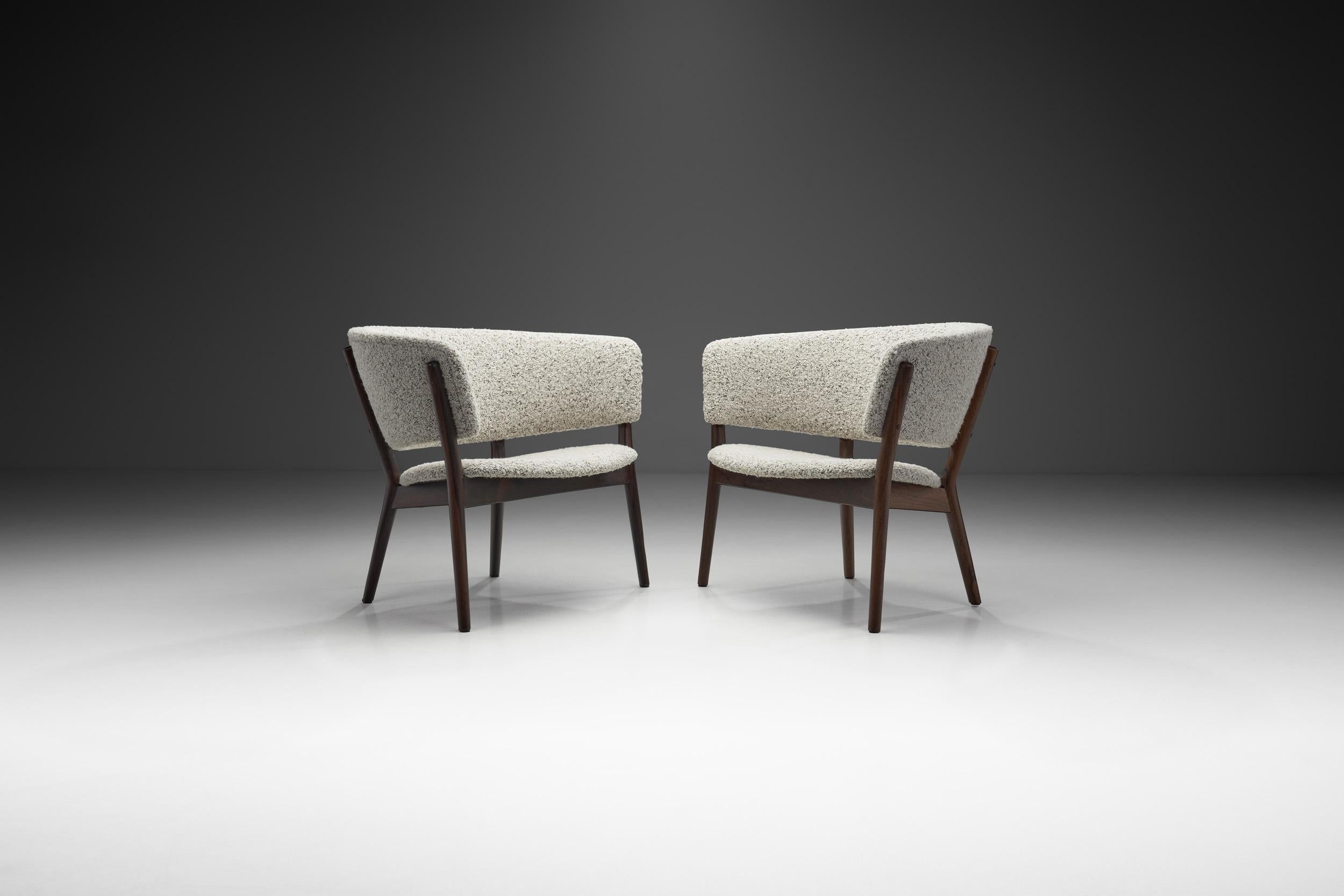 This pair of armchairs is what we consider a timeless Danish Modern classic. The “ND83” was designed in 1952 by Nanna Ditzel for the exhibition 'Today’s Furniture, Home Equipment' in the Forum Hall Copenhagen in 1952.

Chairs are often considered