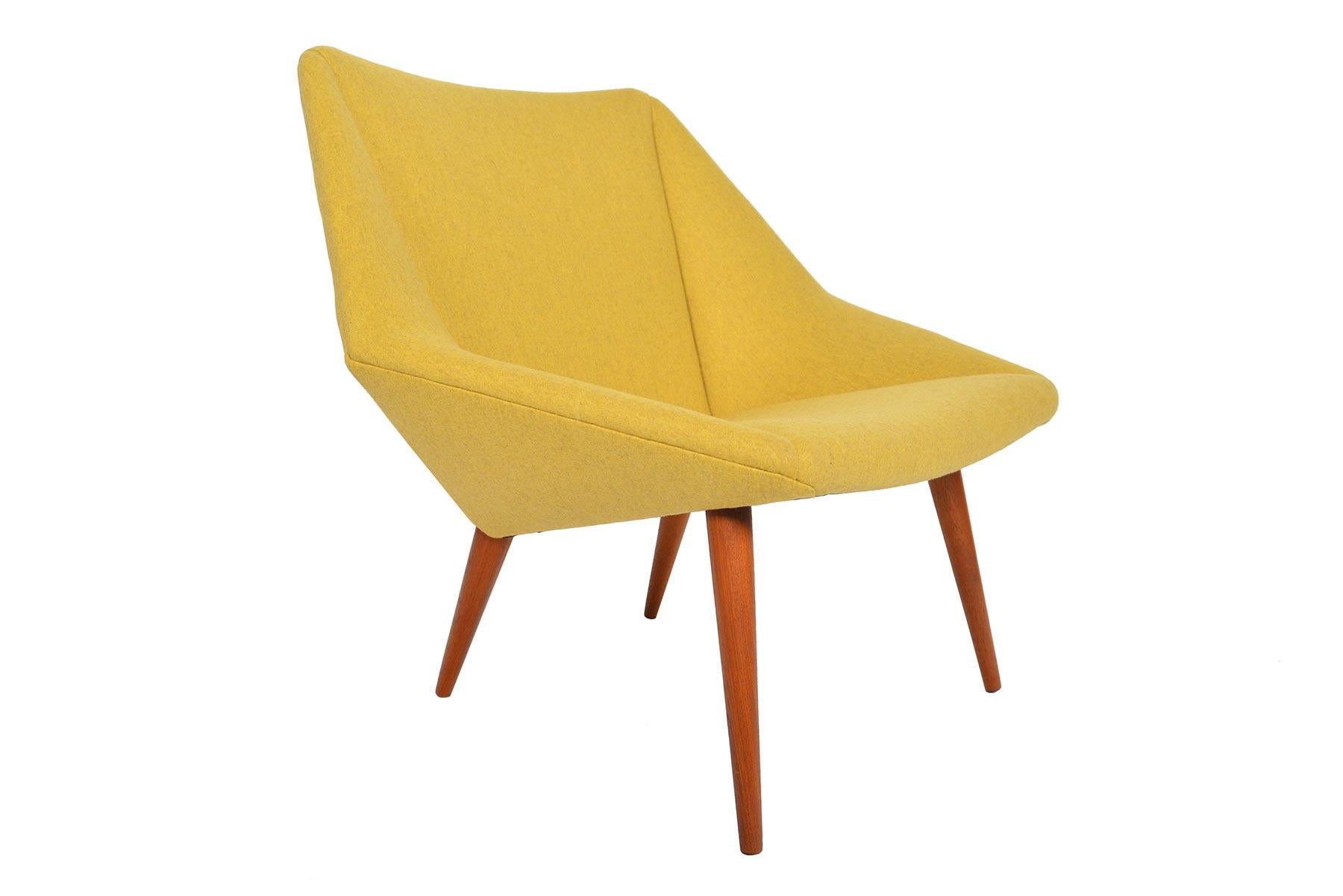 This jewel-cut lounge chair was designed by Nanna Ditzel for Søren Willadsen Møbelfabrik in 1955 as the ‘Tux’ chair Model 93. This vintage low back version has been upholstered in goldenrod Jefferson wool by Kravet. Chair stands on teak spindle