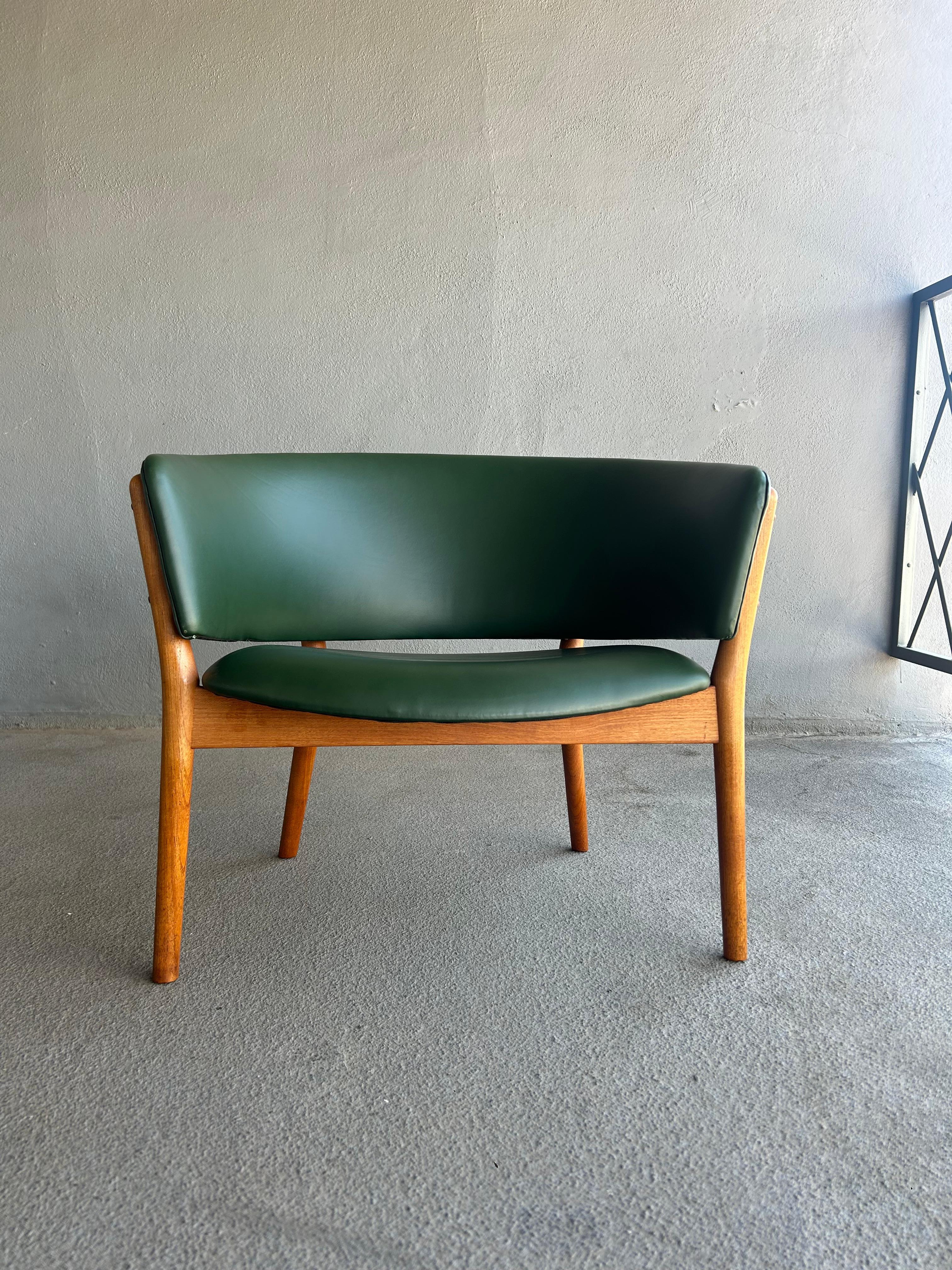 Nanna Ditzel ND83 lounge chair, circa mid-1950s. This example has been newly upholstered in a supple green leather. Finish to teak frame is original. 