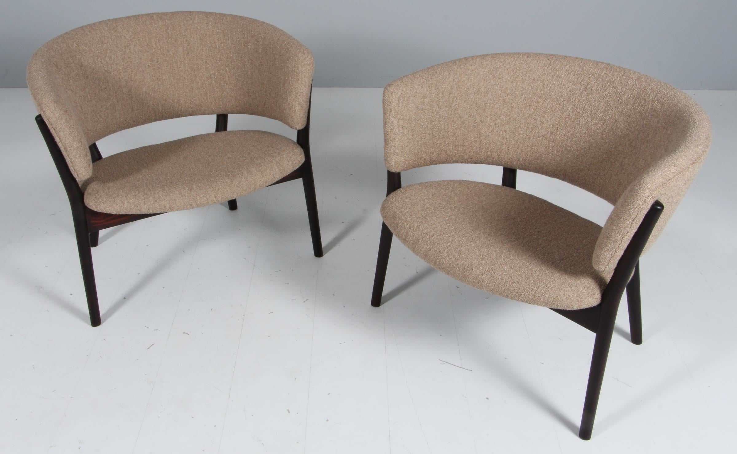 Nanna Ditzel for Soren Willadsen, easy chairs model 'SW83', rosewood, new upholstered with Boucle, Denmark, 1952.

Set of two round lounge chairs with a dark rosewood wooden frame and boucle. The wooden frame is beautifully shaped and gives the