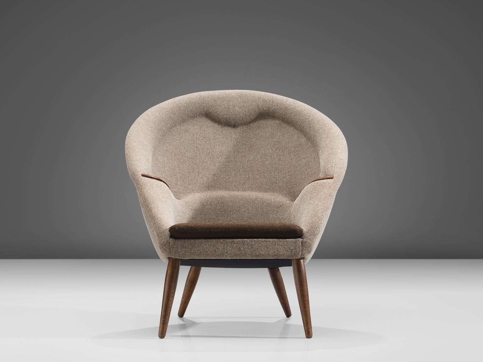 Nanna Ditzel, 'nursing' chair, Kvadrat Hallingdal brown and beige fabric and wood, Denmark, 1953.

This round and comfortable armchair is designed by Nanna Ditzel. The chair features four thick legs that become smaller towards the top and bottom.