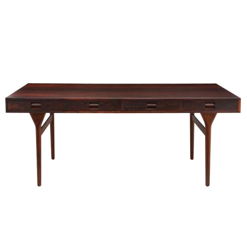 Nanna Ditzel rosewood desk, Denmark, 1960s. Rectangular top with four drawers. Great graining to rosewood. Legs are removable.