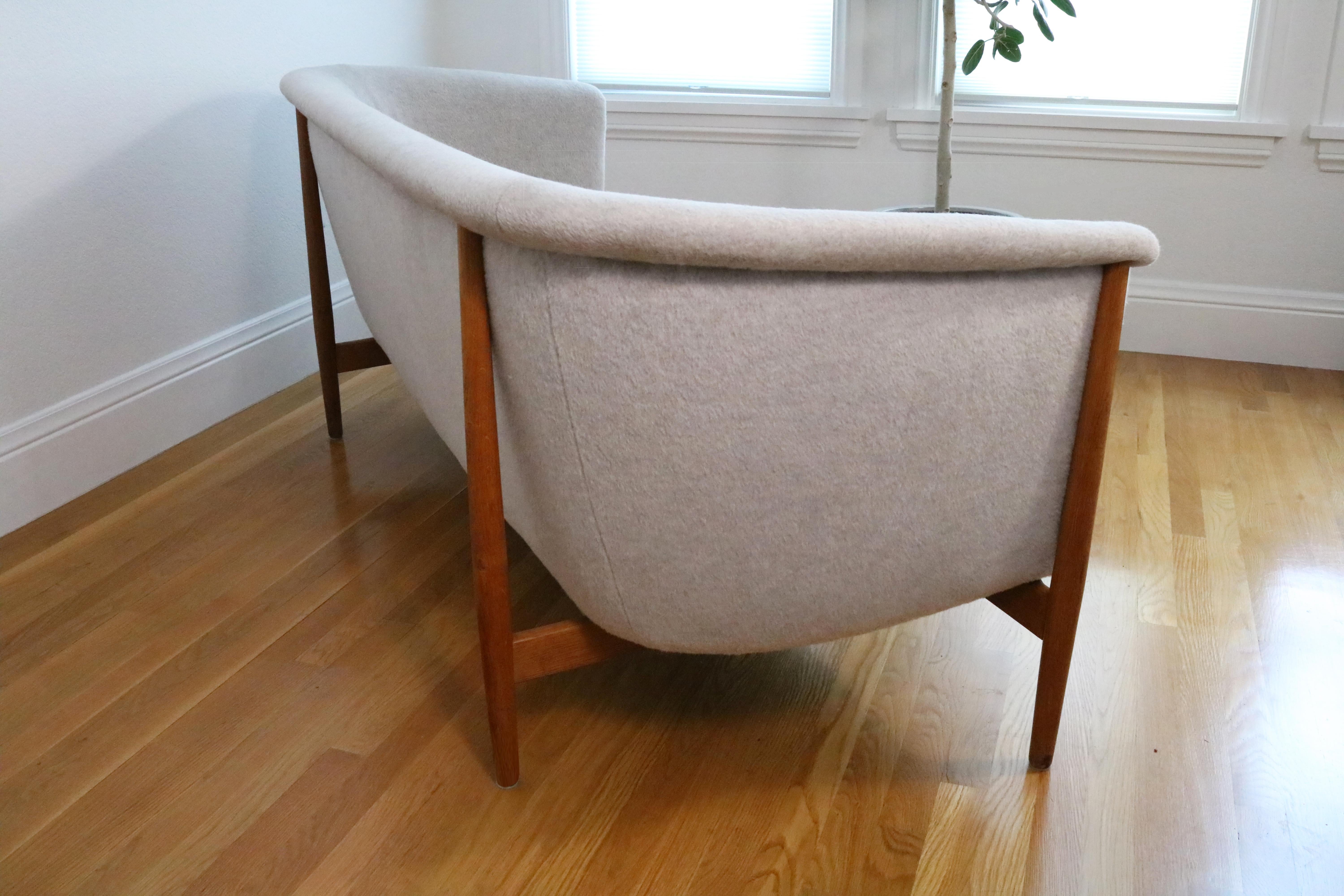 A rare and iconic Nanna Ditzel sofa for Søren Willadsen, designed and manufactured in the 1950s.

Recently reupholstered in luxuriously soft premium pale grey wool upholstery. External frame in old growth white oak.

In excellent vintage condition.