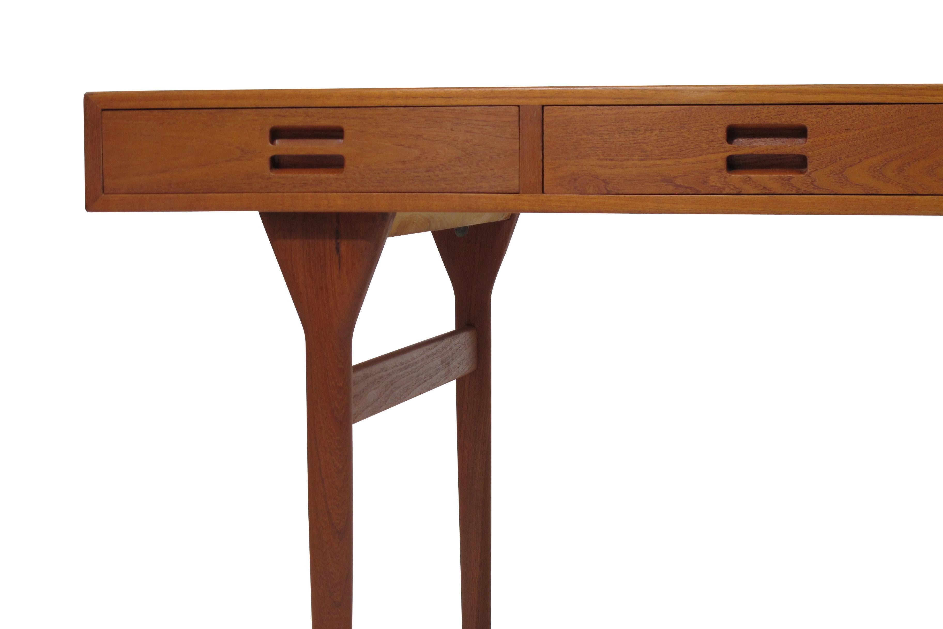 Executive desk designed by renown Danish designer Nanna Ditzel for Soren Willadsen Mobelfabrik, Model ND 93, circa 1955 Denmark. The desk is handcrafted of fine growth teak and features series of four drawers and sculpted pulls. Finely restored in