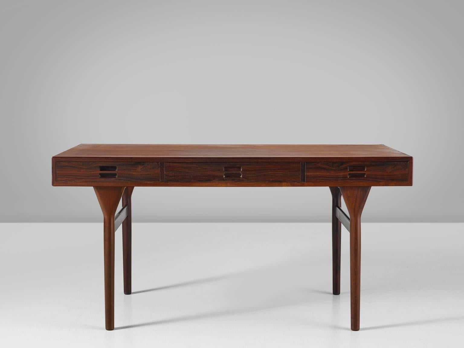 Nanna Ditzel for Søren Willadsen, desk, in rosewood, by Denmark, design 1958, production, 1960s.

Elegant designed freestanding desk designed by one of the best known Danish designers Nanna Ditzel. It creates its strength and beauty due to simple