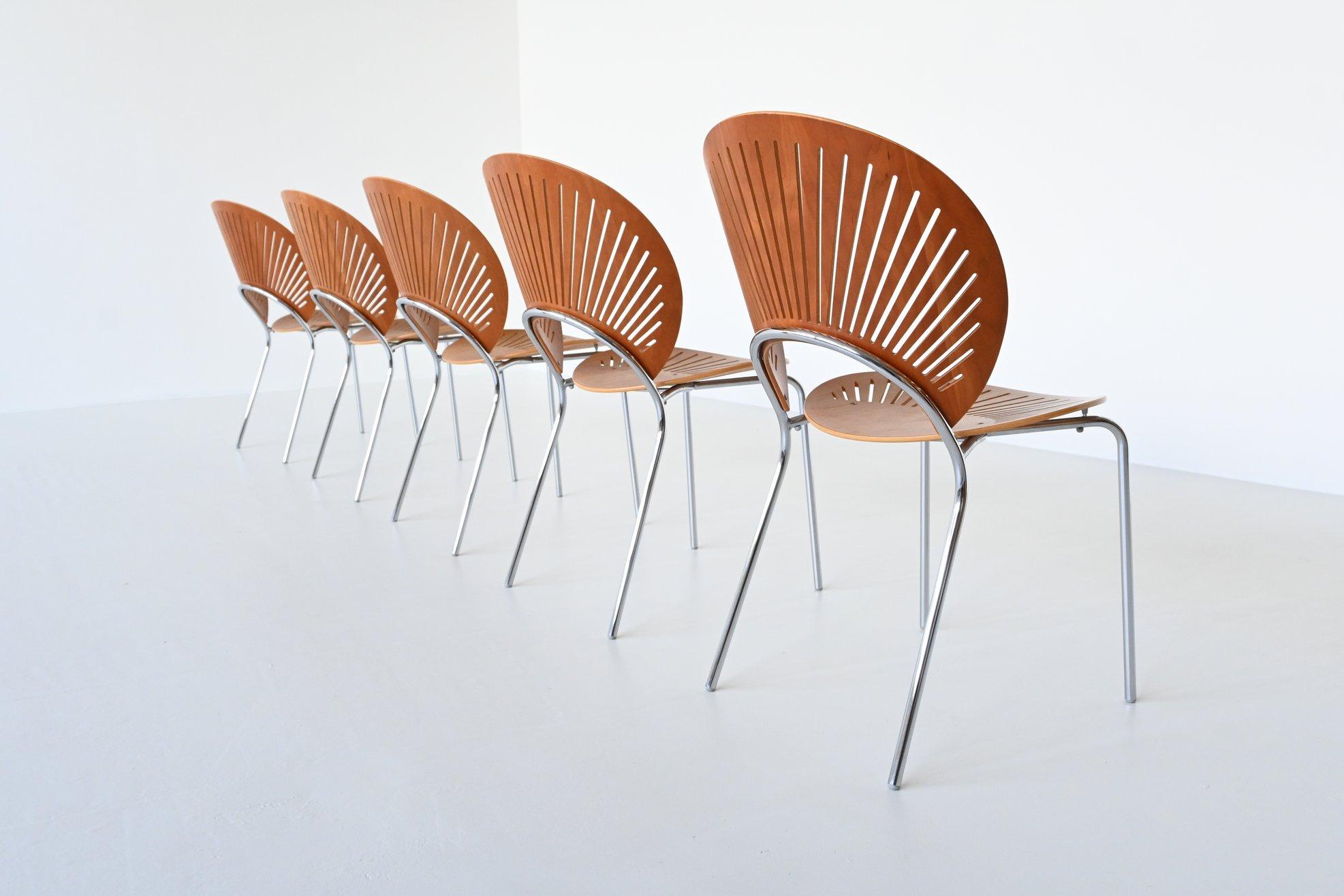 Very nice set of five Trinidad dining chairs model 3298 designed by Nanna Ditzel for Fredericia Stolefabrik, Denmark 1990. These beautiful shaped dining chairs have shells of beech wood with a chrome plated tubular metal frame. The design is defined